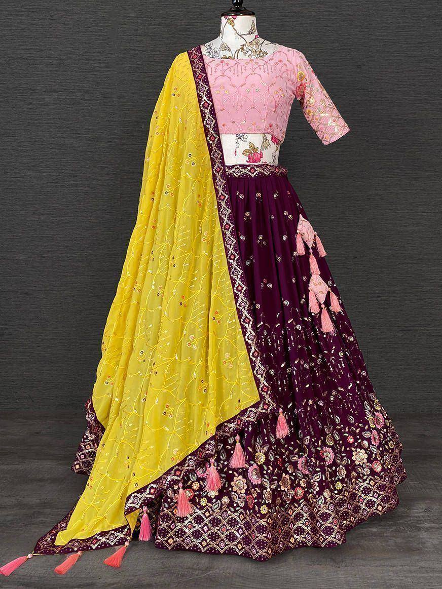 Pink and purple embroidered lehenga choli with yellow dupatta, floral tassels, and mirror work for Indian ethnic wear