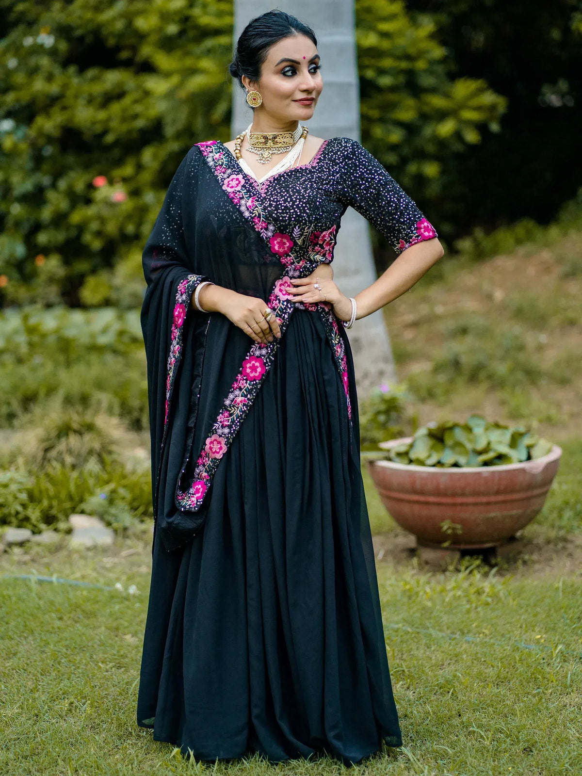 Black floral embroidered ethnic gown with pink detailing, perfect for Indian celebrations