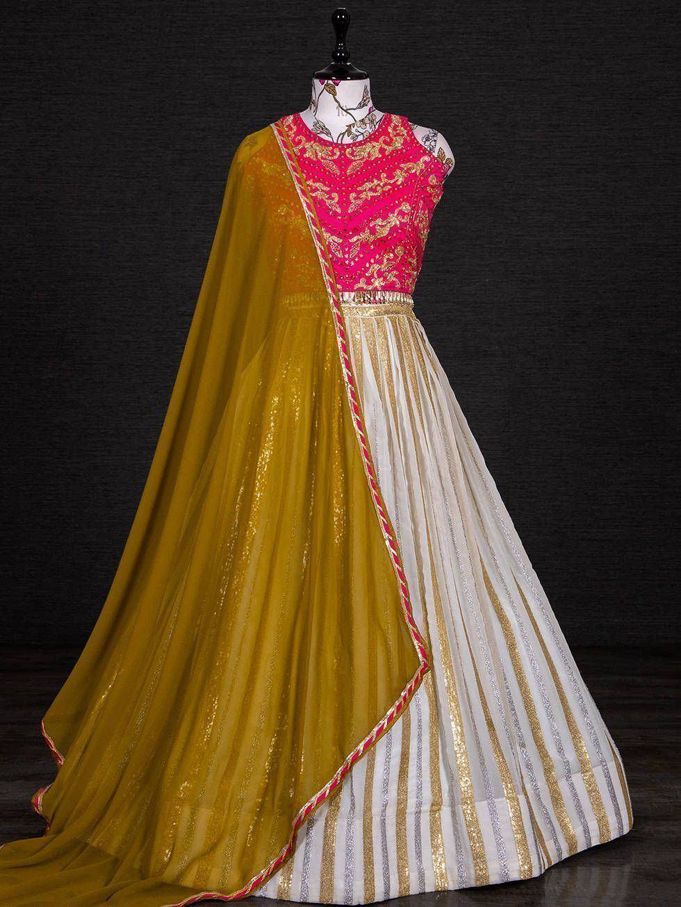 Pink embroidered lehenga choli with gold and white striped skirt and mustard dupatta, ethnic Indian wear