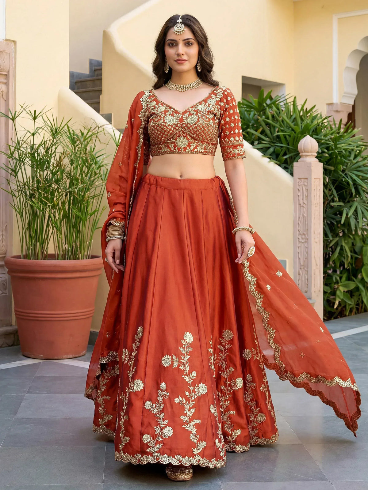 Elegant terracotta lehenga choli with gold embroidery, perfect for Indian ethnic wear