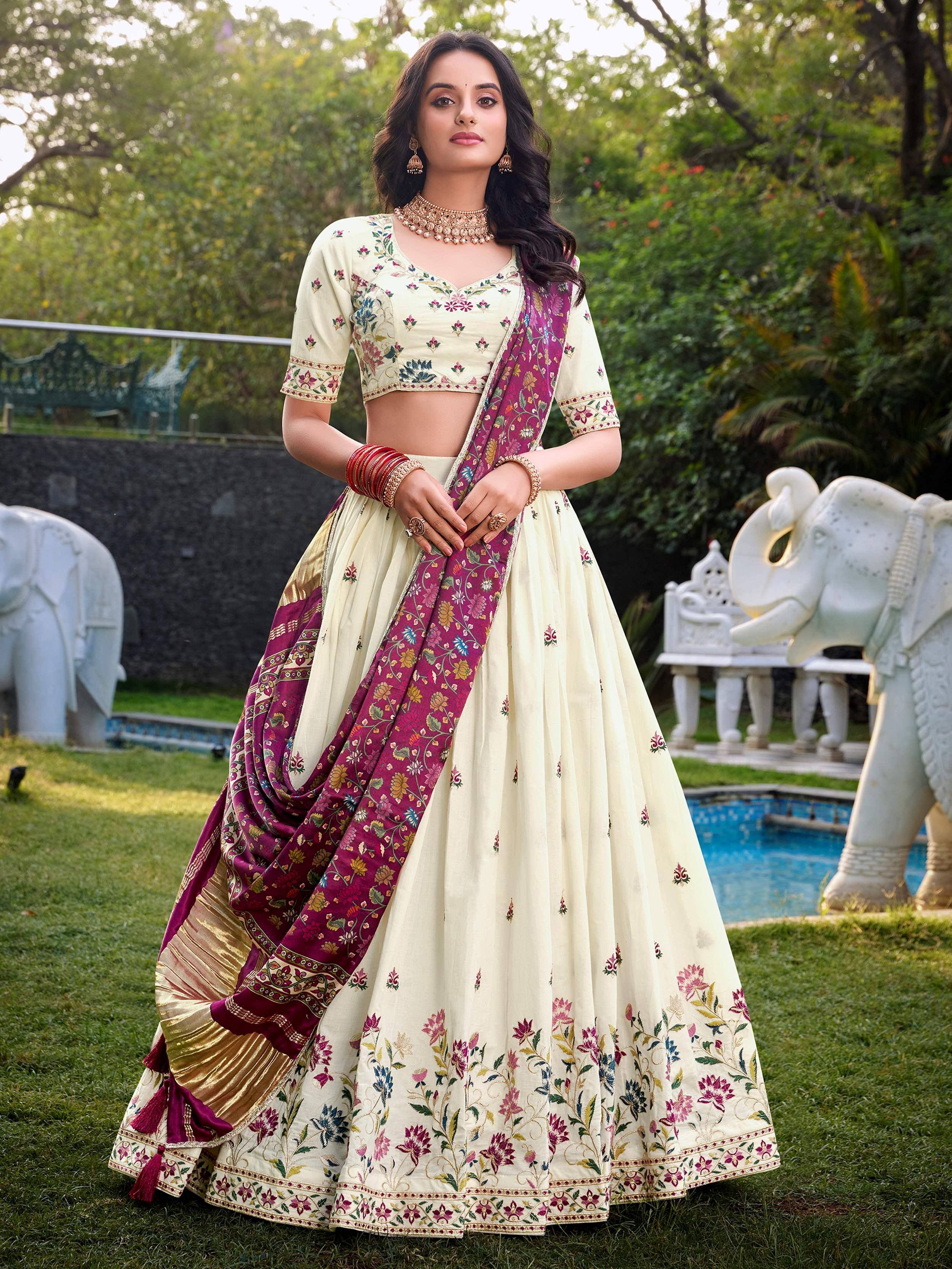 Cream floral embroidered lehenga choli with maroon dupatta, perfect for Indian weddings and festive occasions.