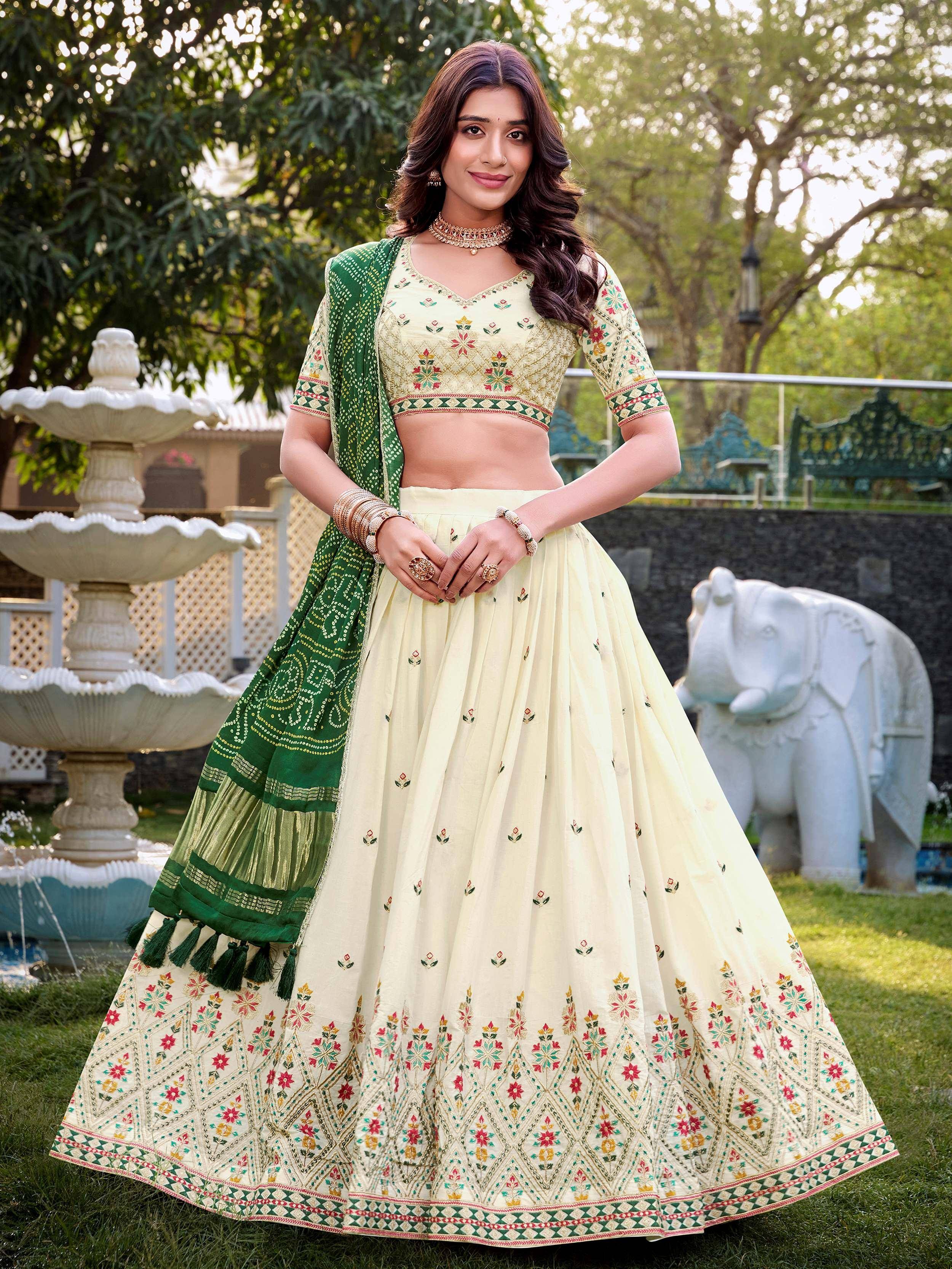 Cream and green embroidered lehenga choli with floral motifs, perfect for Indian ethnic occasions.