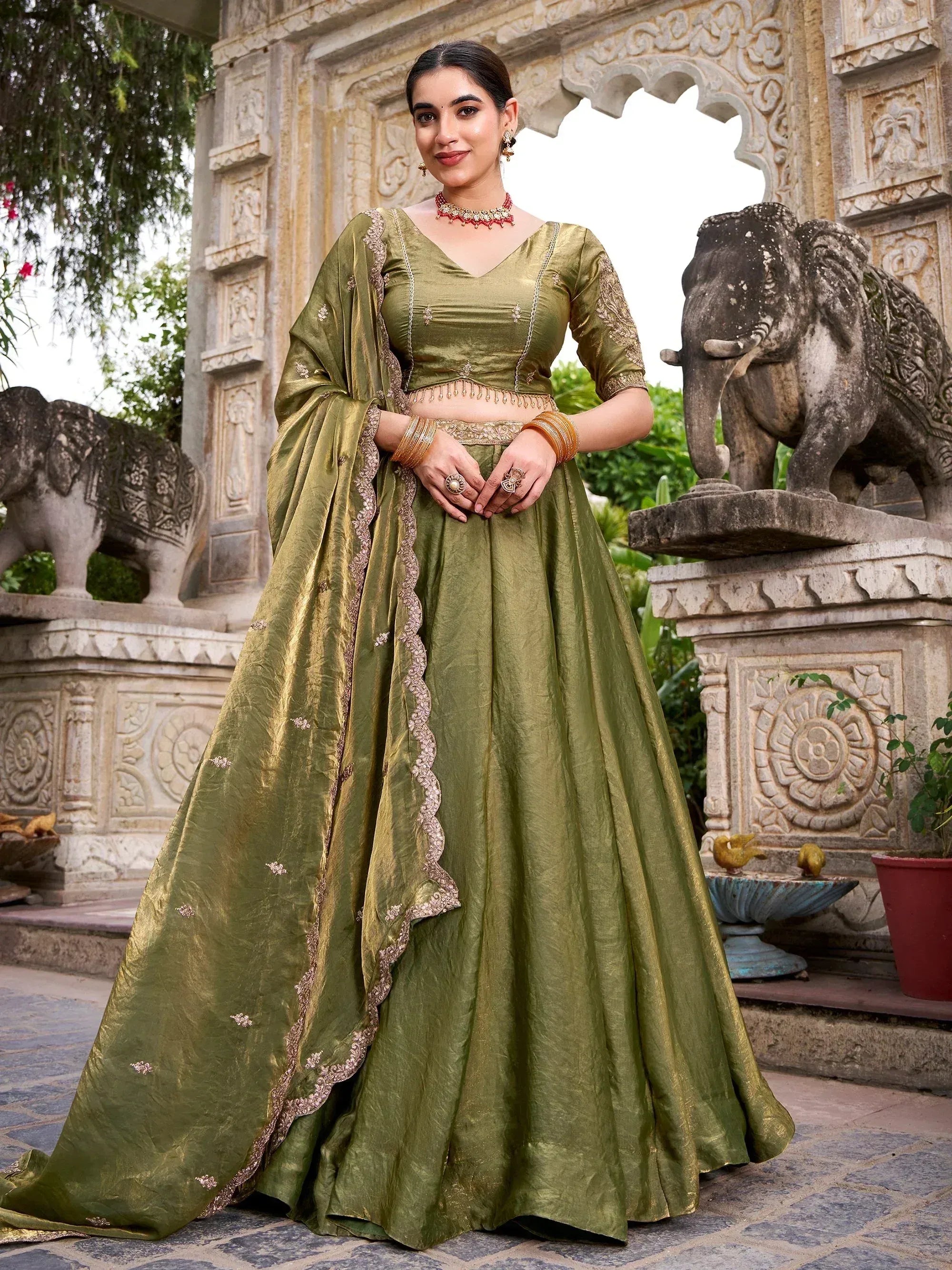 Olive green designer lehenga choli with gold embroidery, perfect for Indian ethnic occasions and weddings.