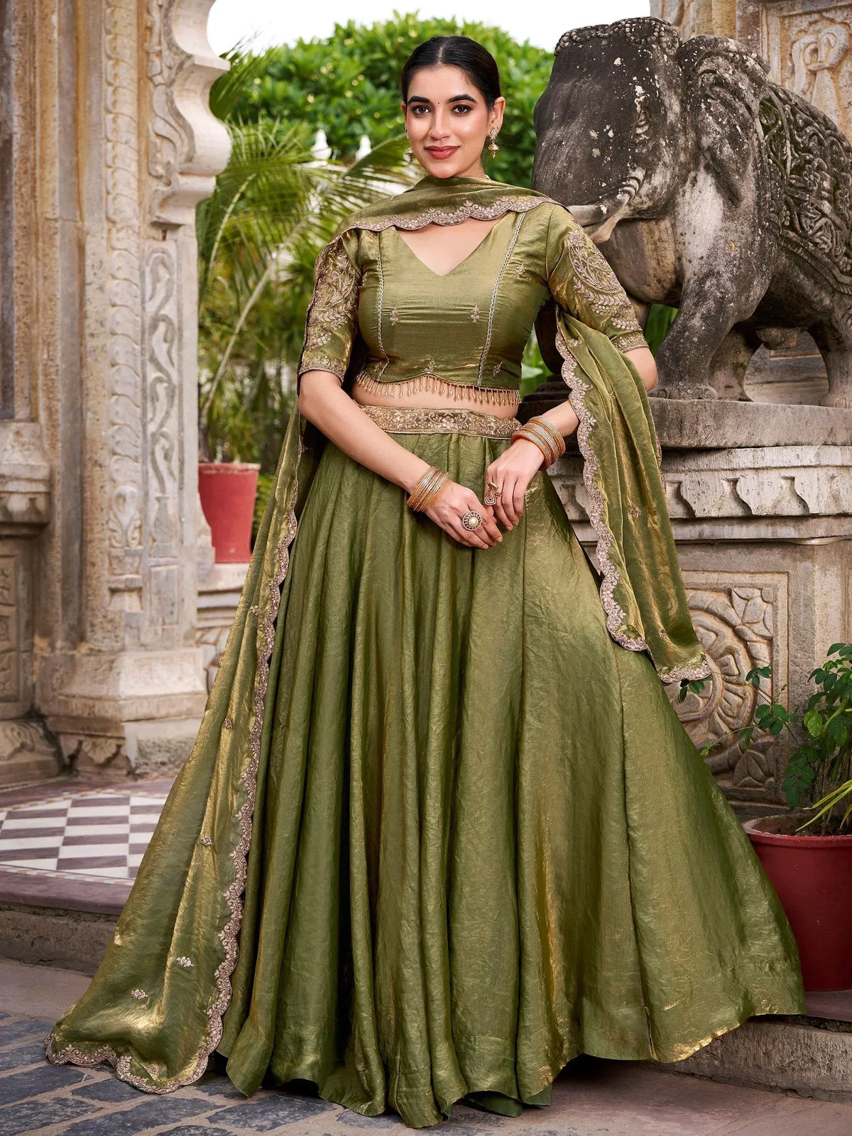 Olive green designer lehenga choli with gold embroidery, perfect for Indian ethnic wear and festive occasions.