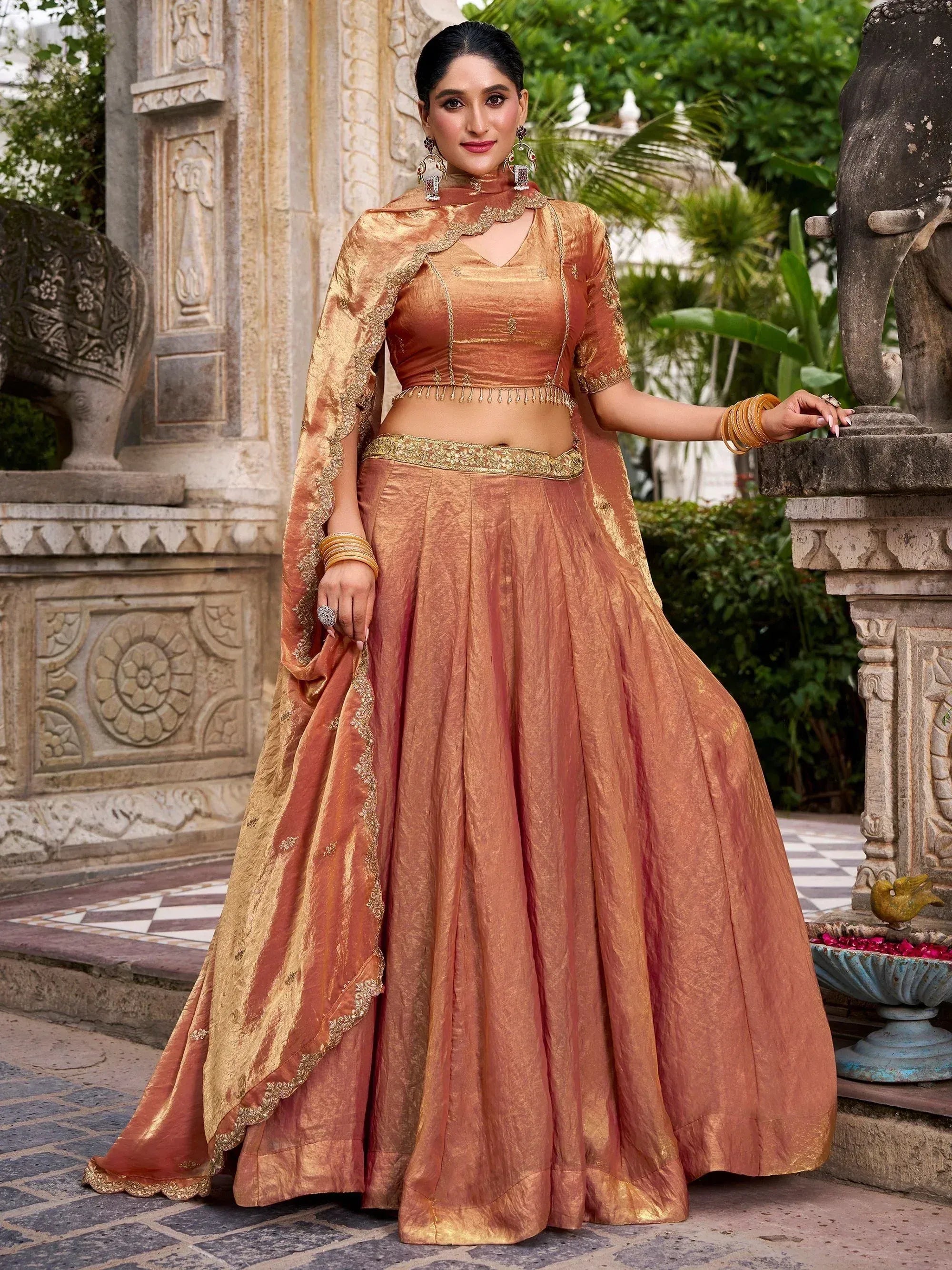 Elegant peach lehenga choli with gold embroidery, perfect for Indian weddings and festive occasions