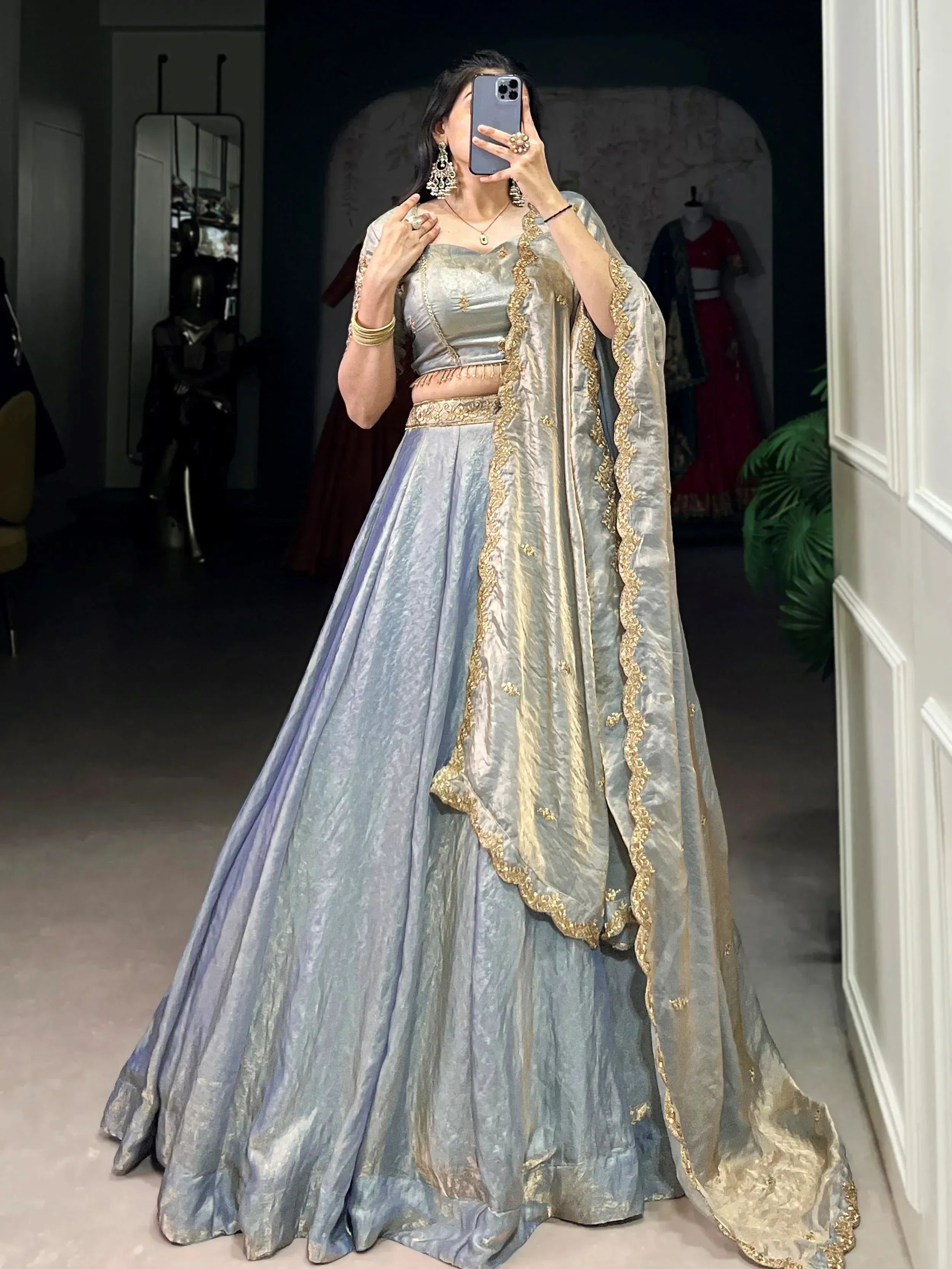 Elegant silver lehenga choli with gold embroidery, perfect for Indian ethnic wear and festive occasions.