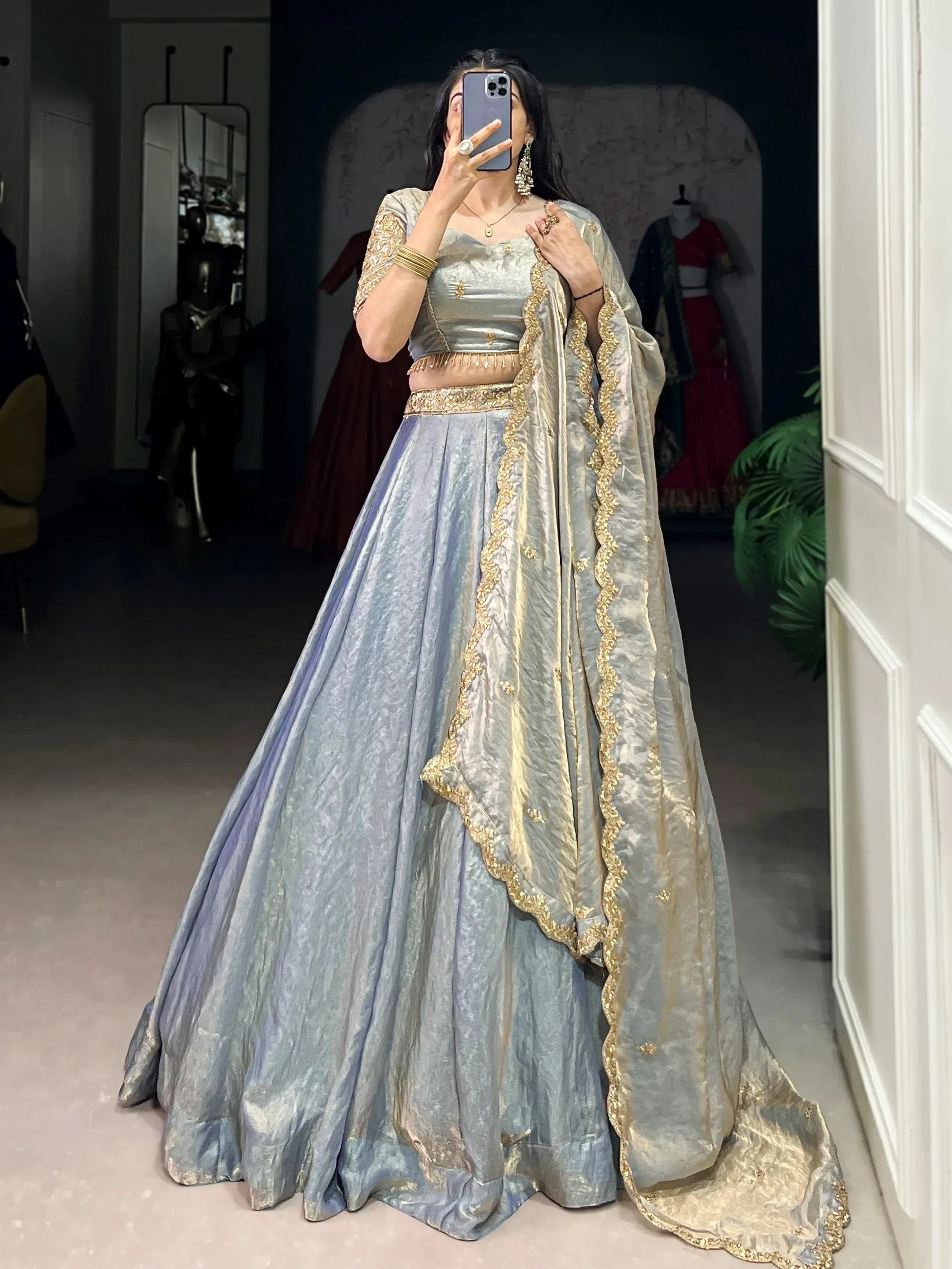 Elegant silver lehenga choli with gold embroidery, perfect for Indian weddings and festive occasions.