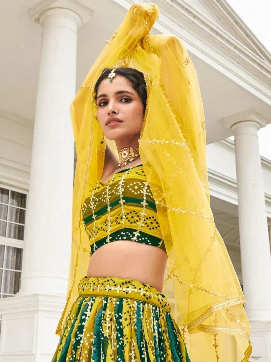 Yellow and green embroidered lehenga choli with sheer dupatta, perfect for Indian ethnic occasions