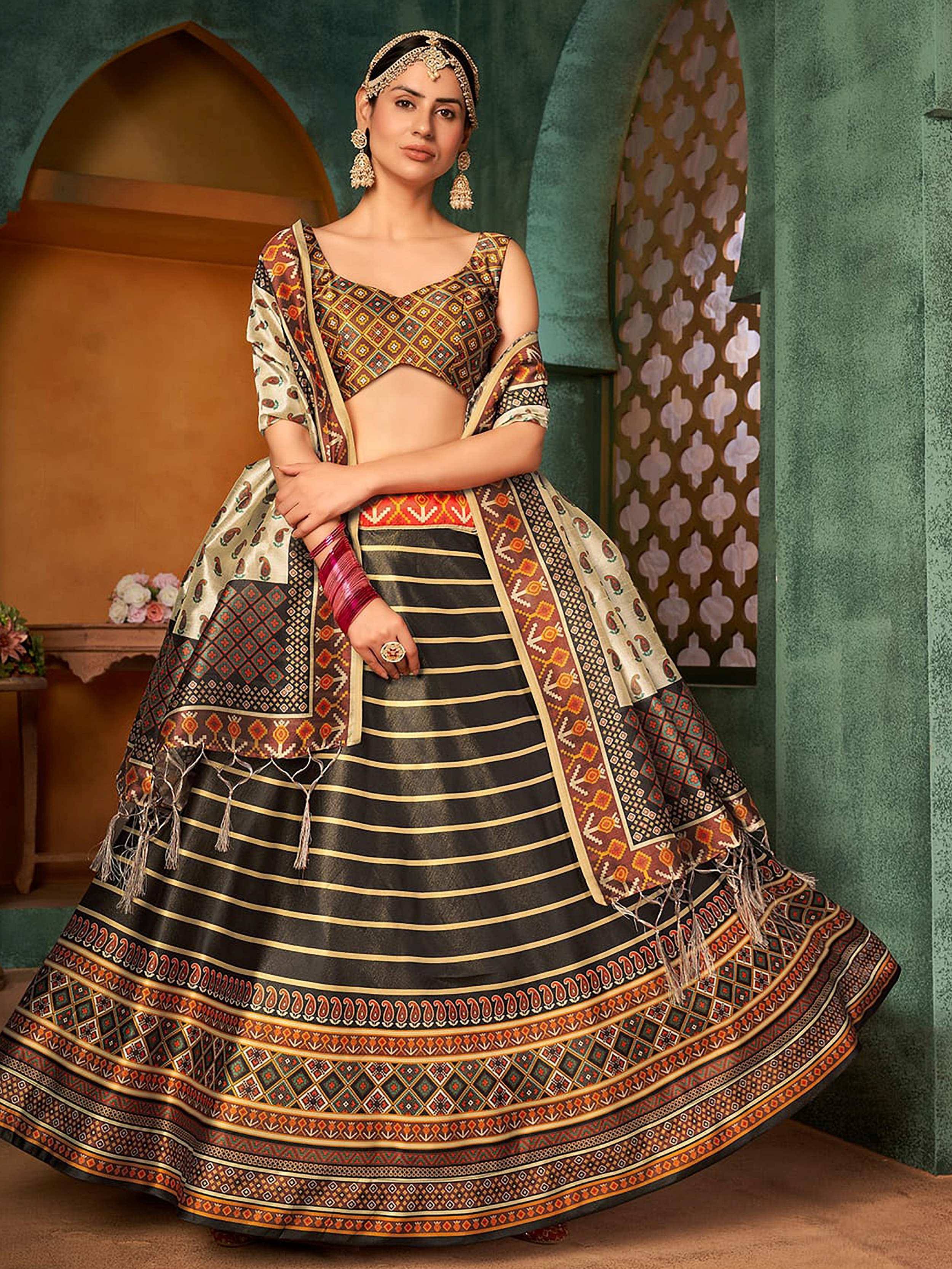 Woman in traditional Indian lehenga choli with intricate geometric patterns and gold stripes, styled with ethnic jewelry.