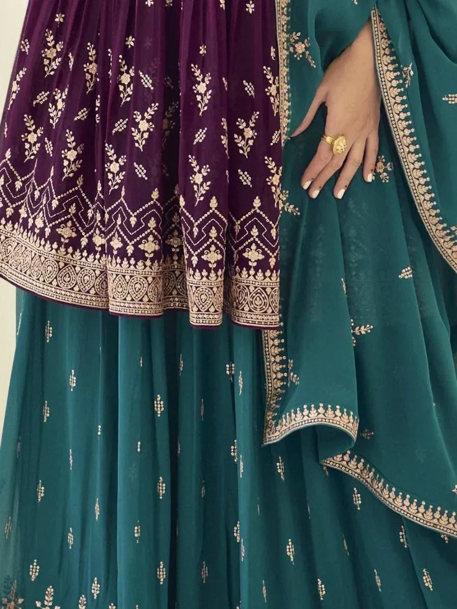 Teal and purple embroidered lehenga choli with gold details, hand with gold ring