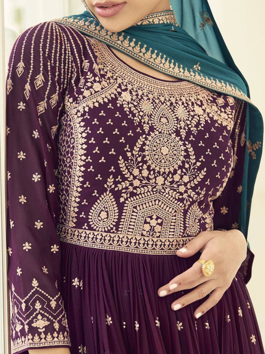 Purple embroidered ethnic gown with gold threadwork and teal dupatta, close-up