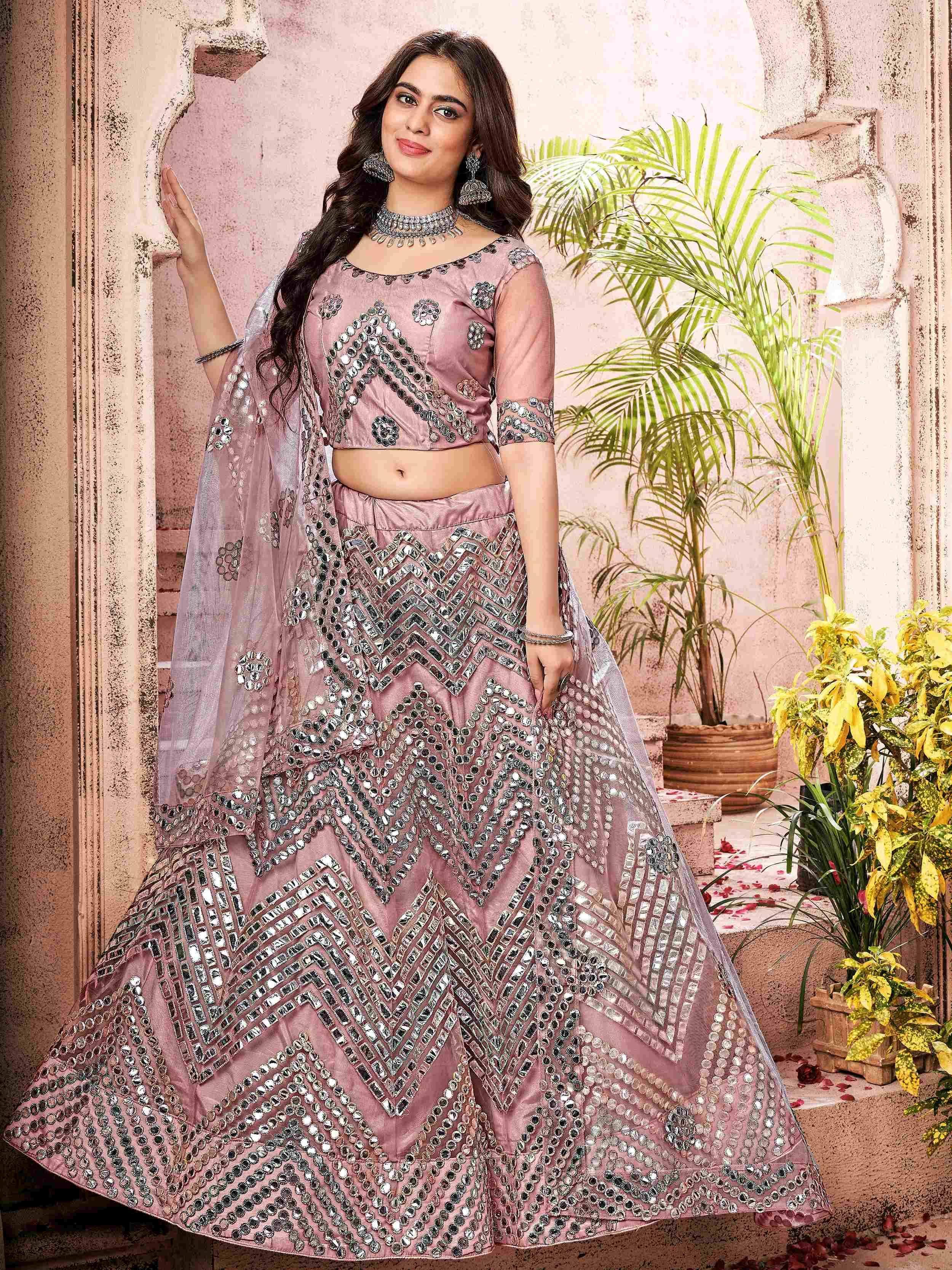 Pink mirror-work lehenga choli with geometric embroidery, perfect for Indian ethnic wear events