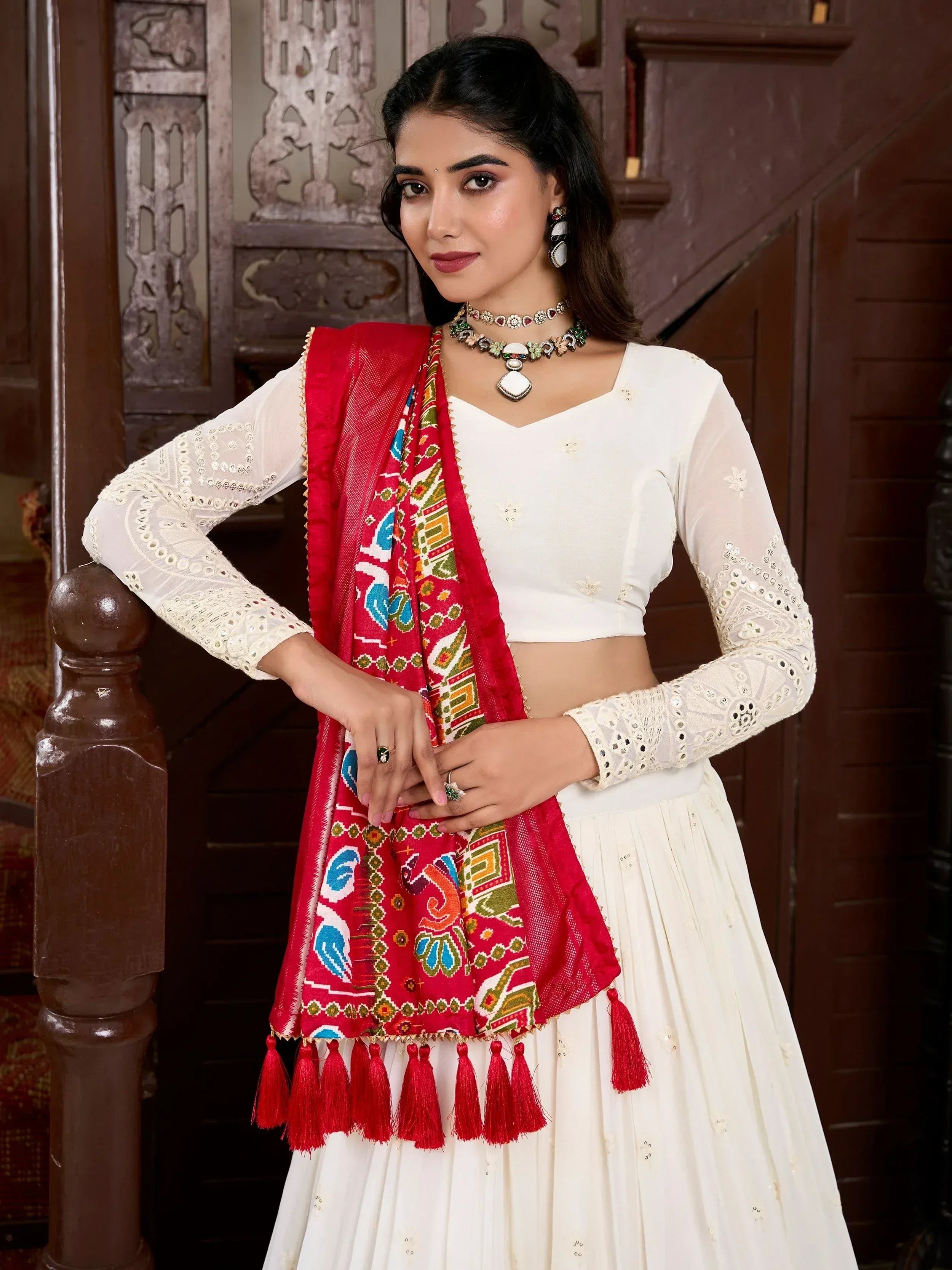 White embroidered lehenga with red printed dupatta and tassels, perfect for Indian ethnic wear