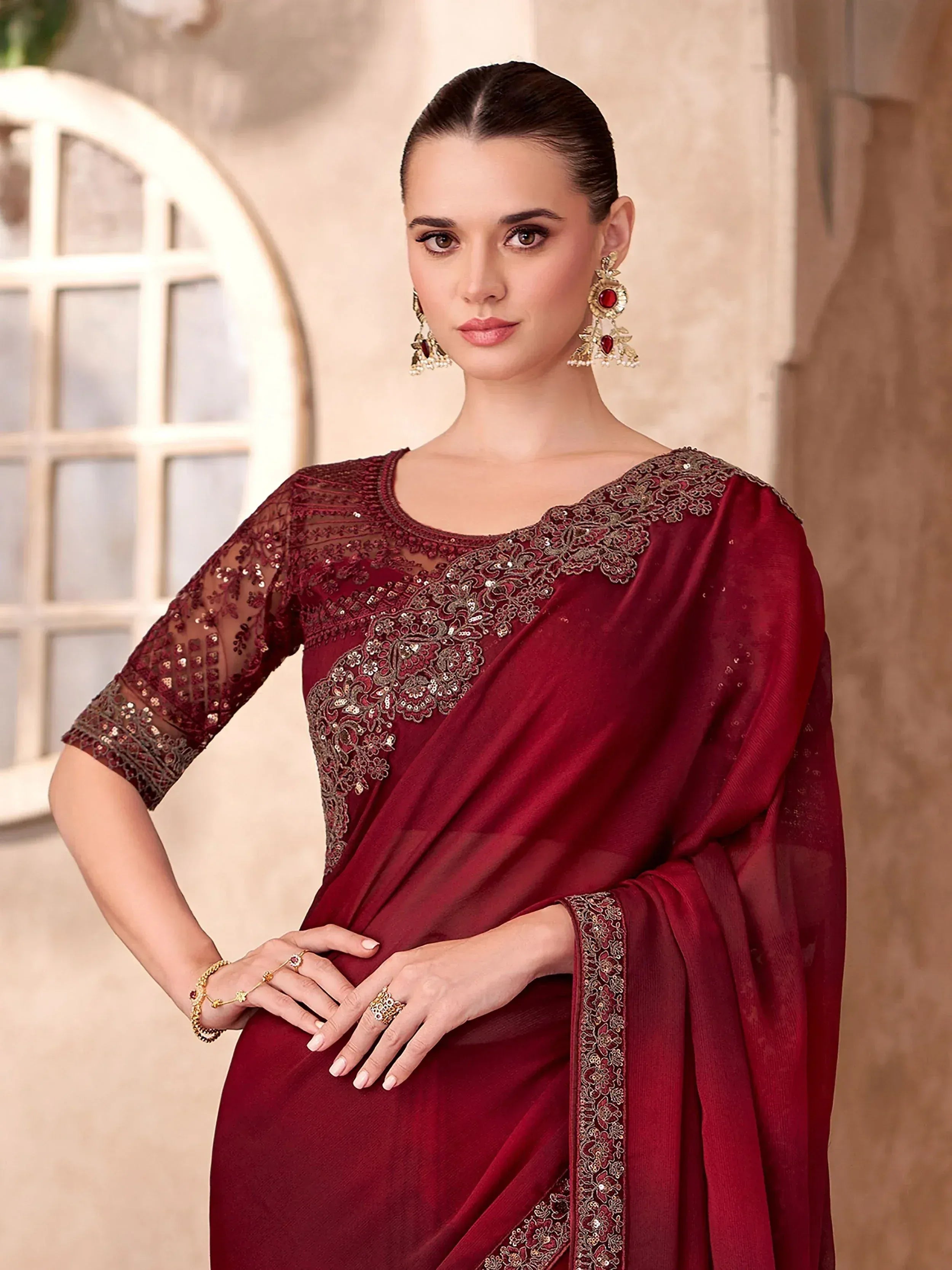 Elegant maroon saree with gold embroidery and sequins, perfect for Indian ethnic occasions.