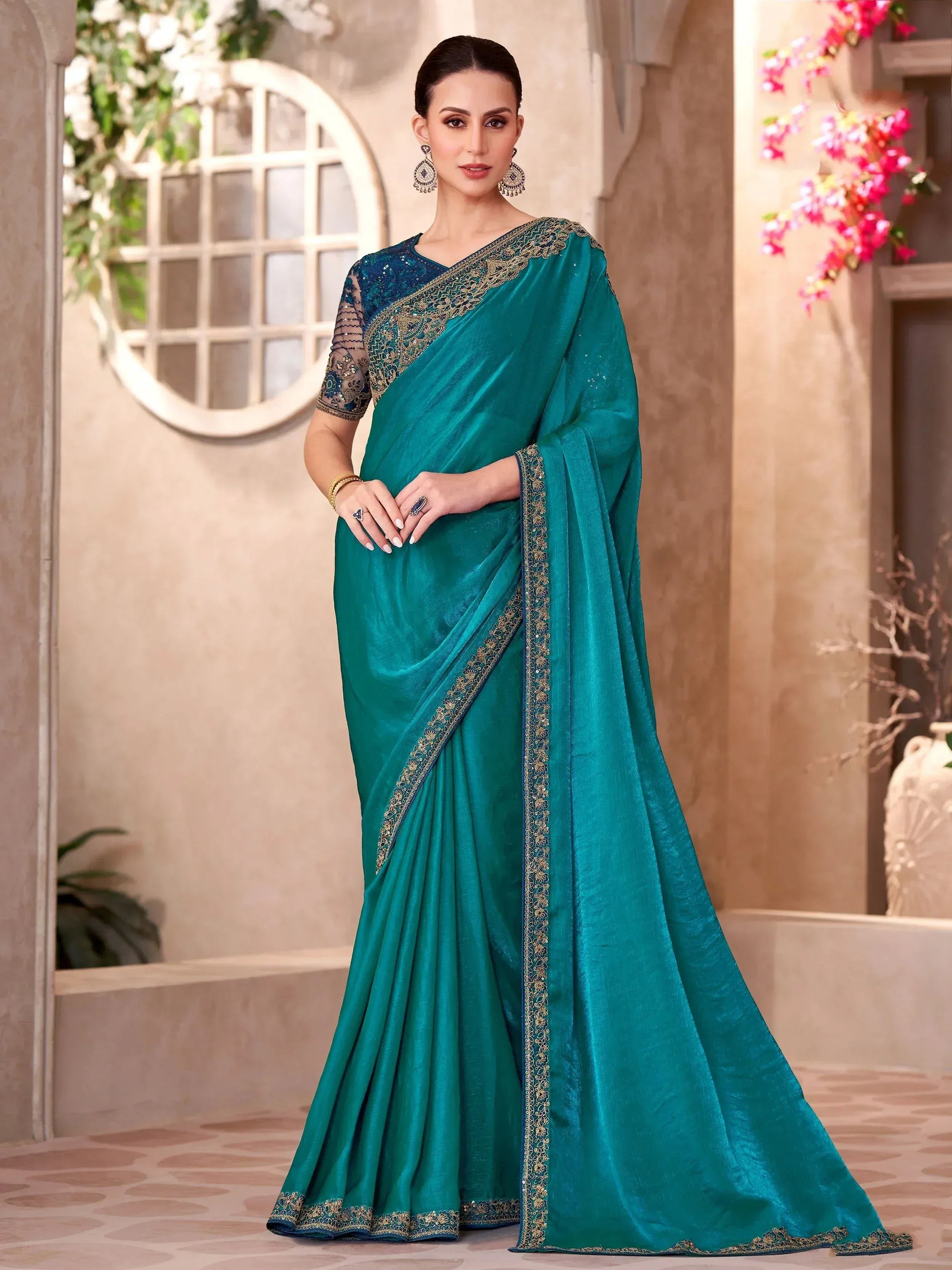 Teal designer saree with gold embroidery and sequin blouse, perfect for Indian ethnic wear occasions.