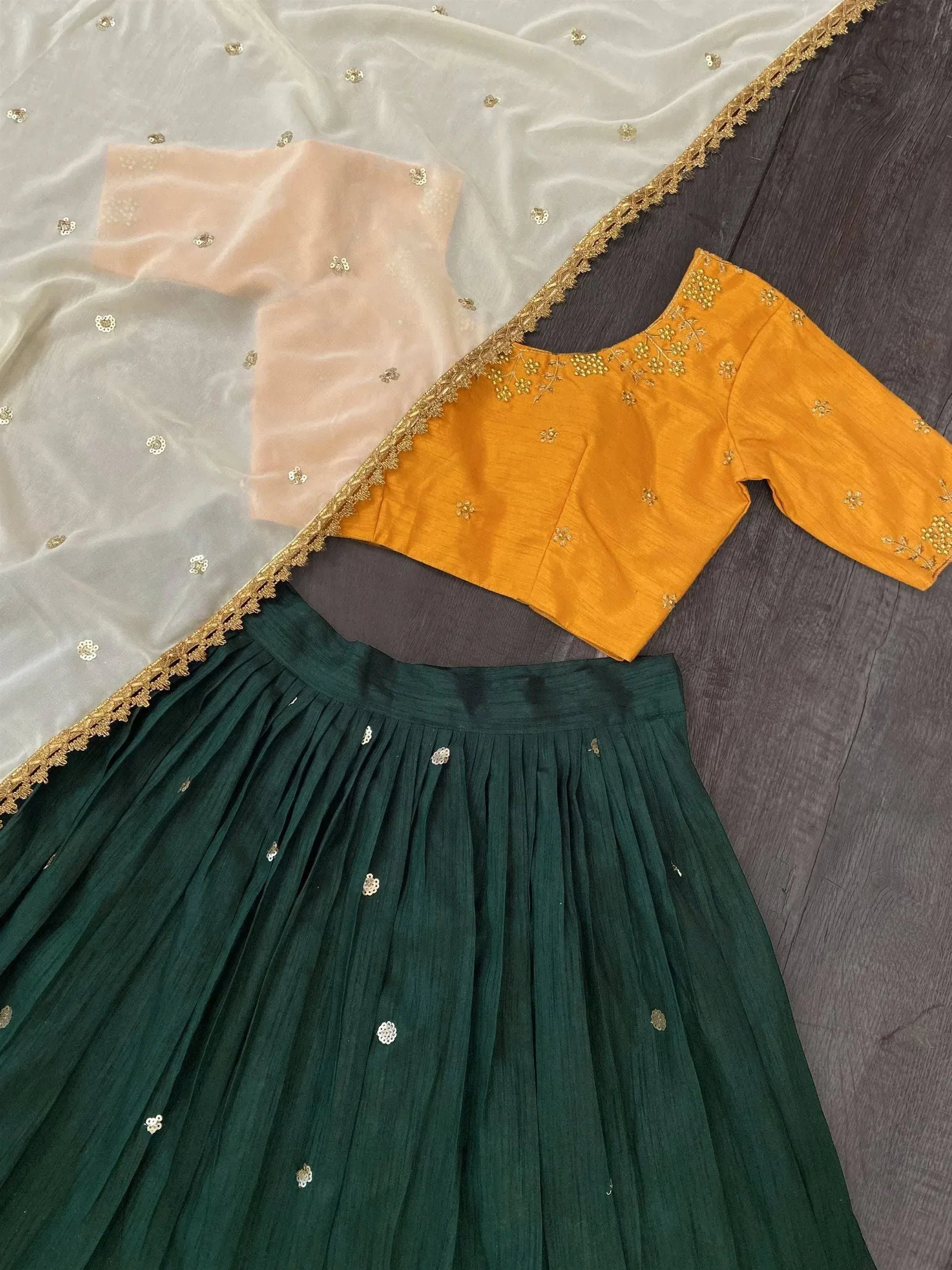 Green pleated lehenga with mustard blouse and sheer dupatta, ethnic Indian wear