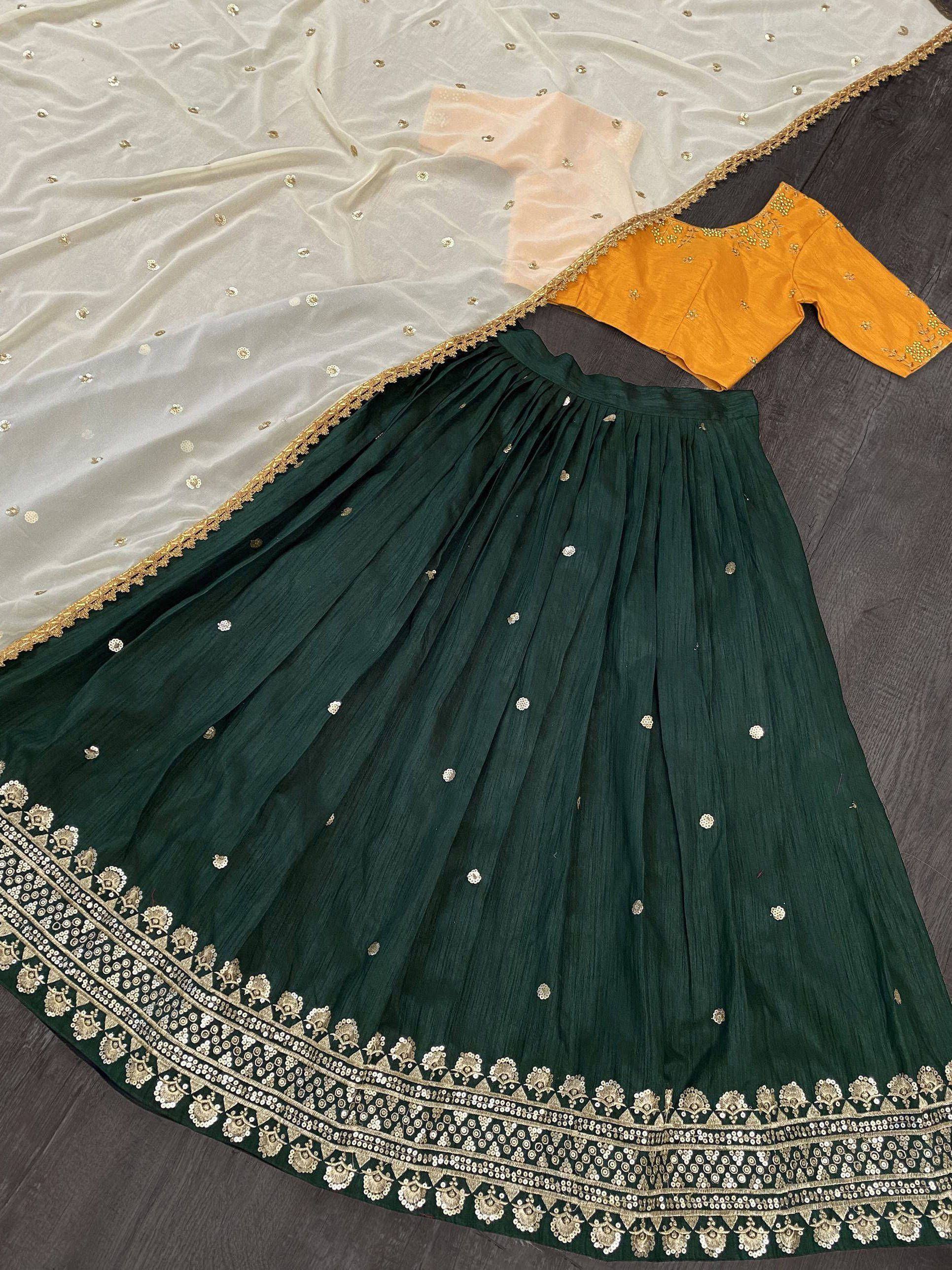Emerald green pleated lehenga with gold embroidery, mustard blouse, and sheer dupatta for Indian ethnic wear