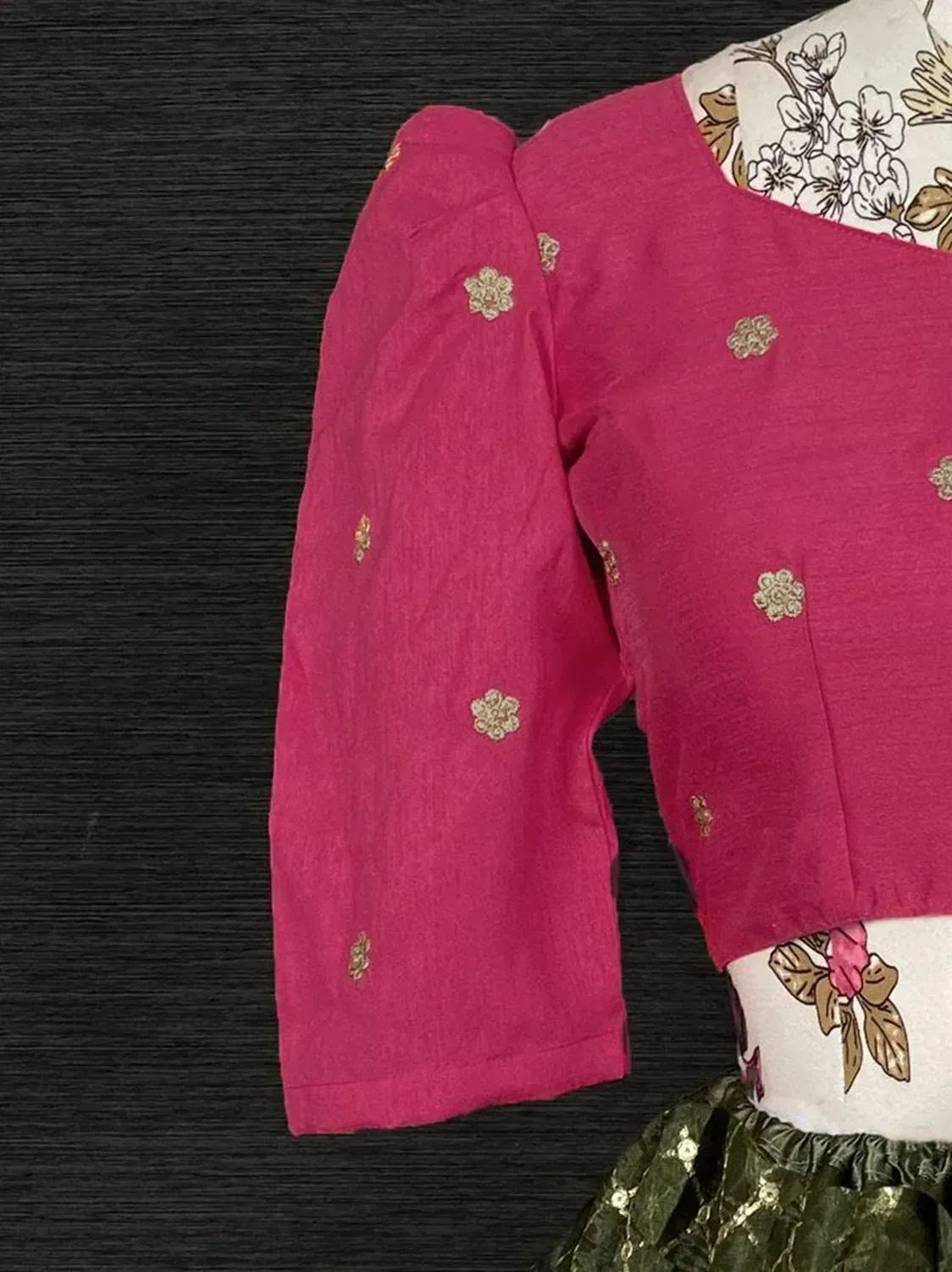 Pink ethnic blouse with gold floral embroidery, paired with printed dupatta and green skirt