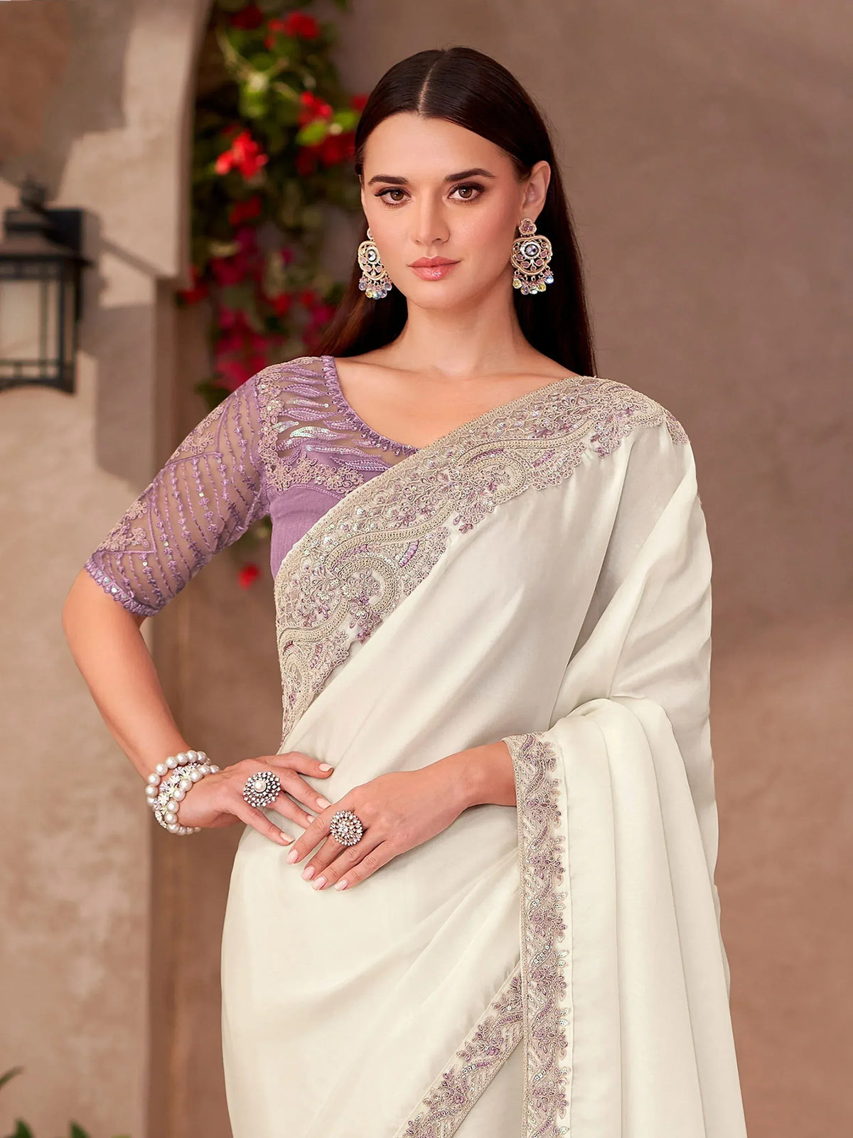 Elegant ivory saree with lavender blouse, intricate embroidery, and designer jewelry for Indian ethnic wear.