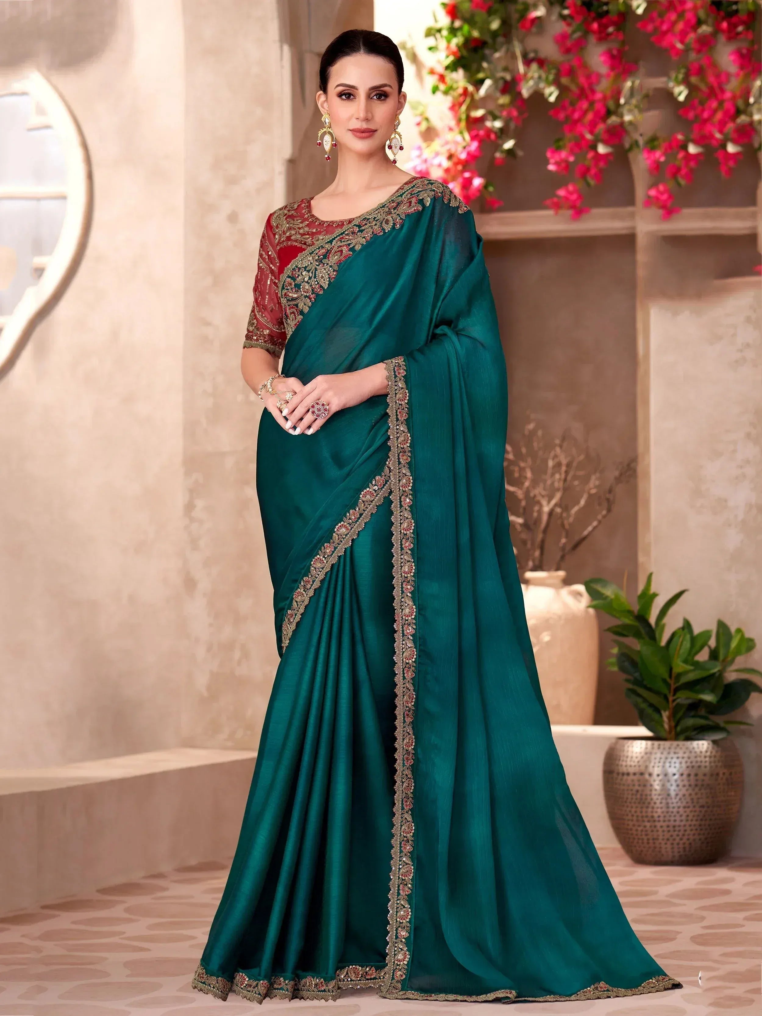 Emerald green designer saree with red blouse, heavy embroidery, perfect for Indian ethnic wear occasions.
