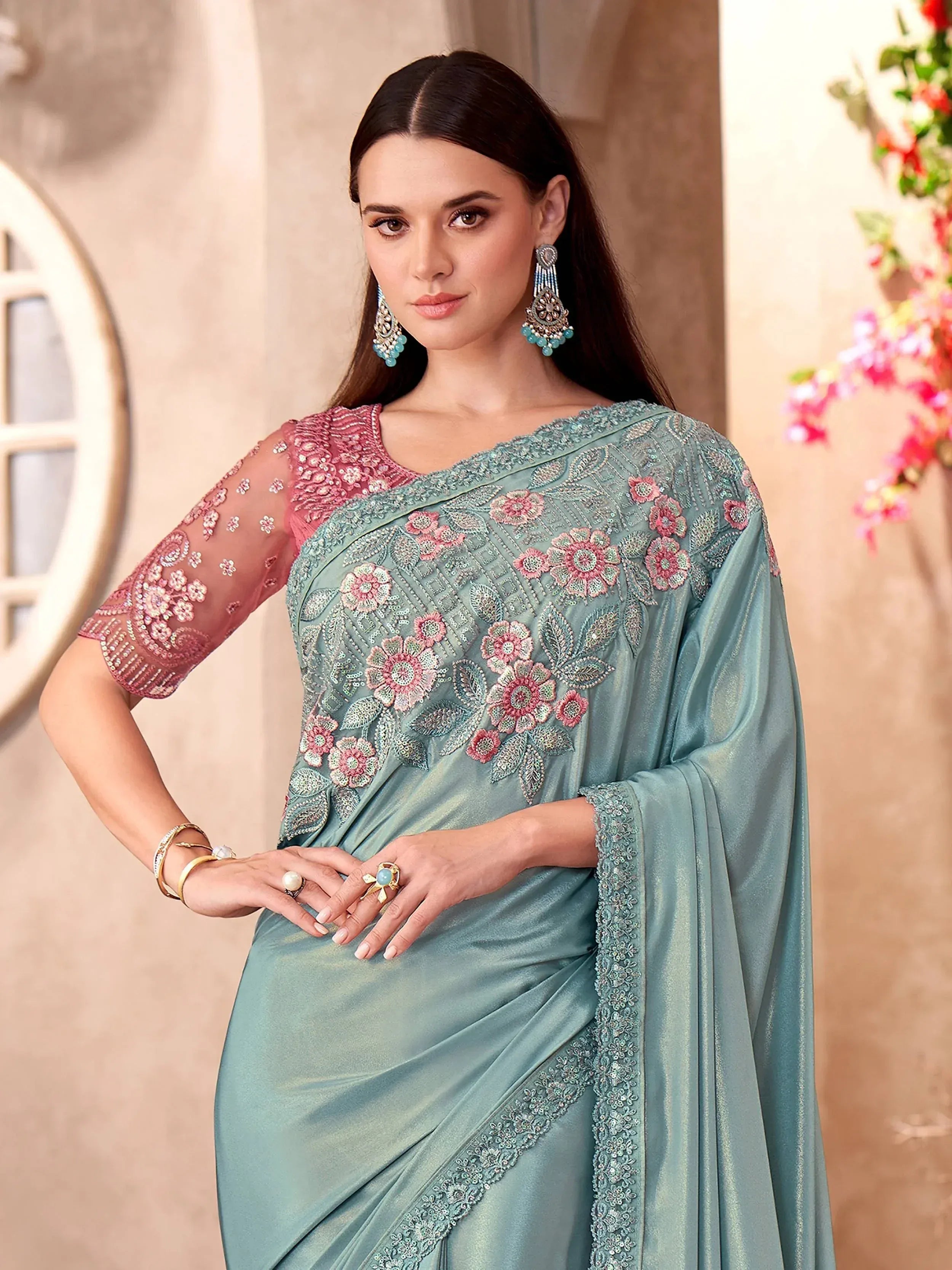 Elegant teal saree with floral embroidery and pink blouse, perfect for Indian ethnic wear occasions.