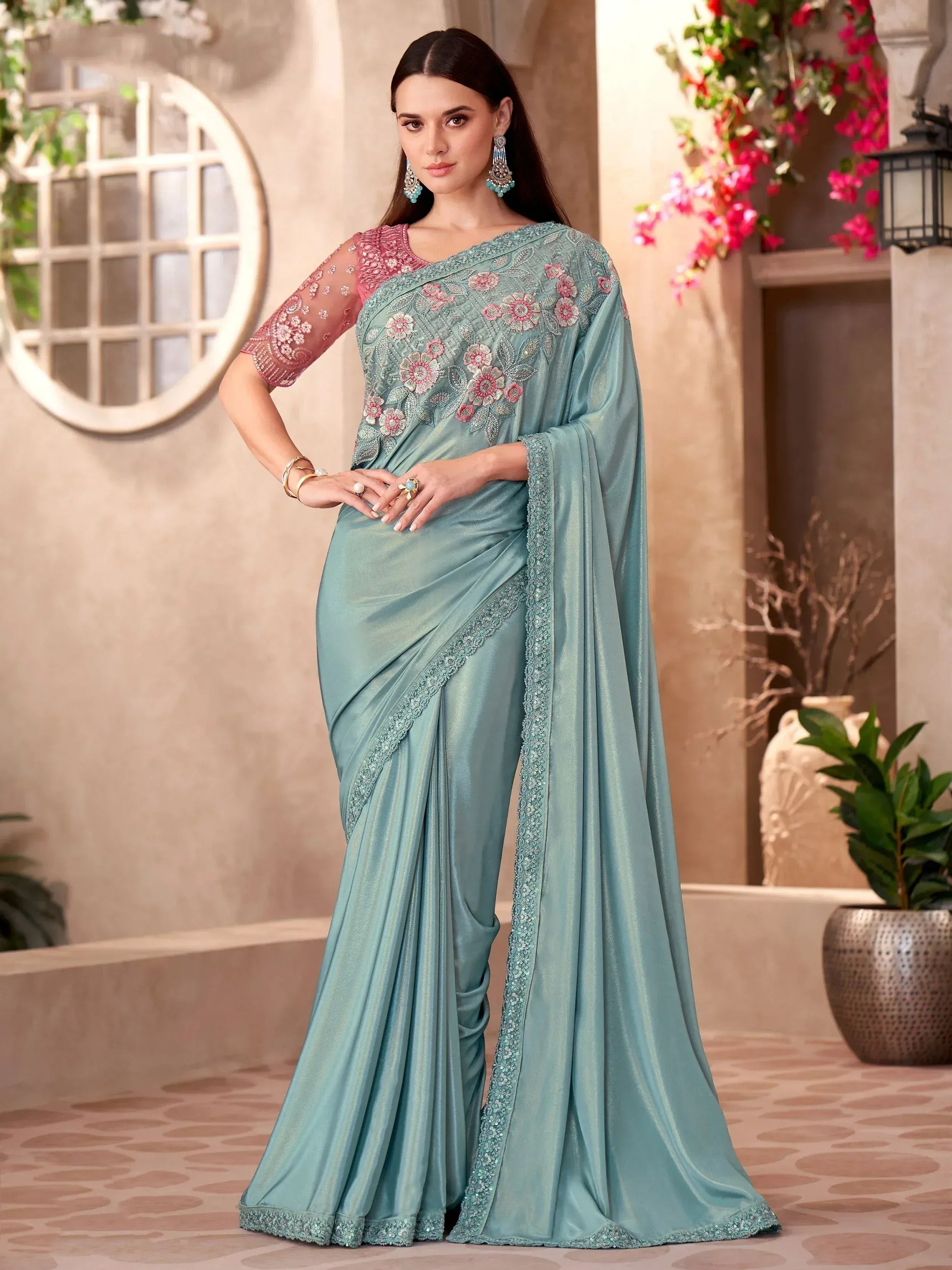 Elegant teal saree with floral embroidery and pink blouse, perfect for Indian ethnic occasions.