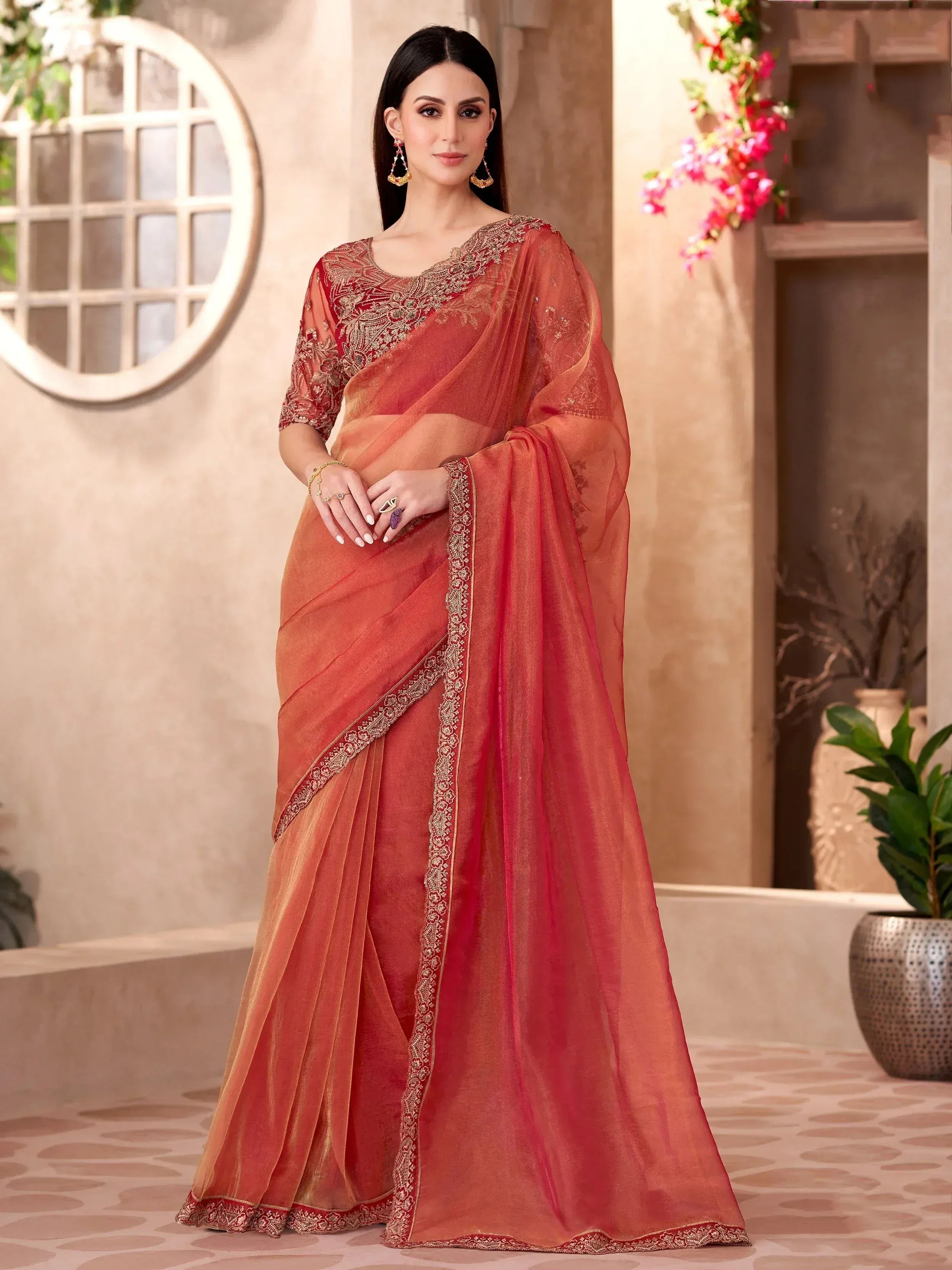 Elegant coral saree with gold embroidery, perfect for Indian ethnic occasions and festive wear.