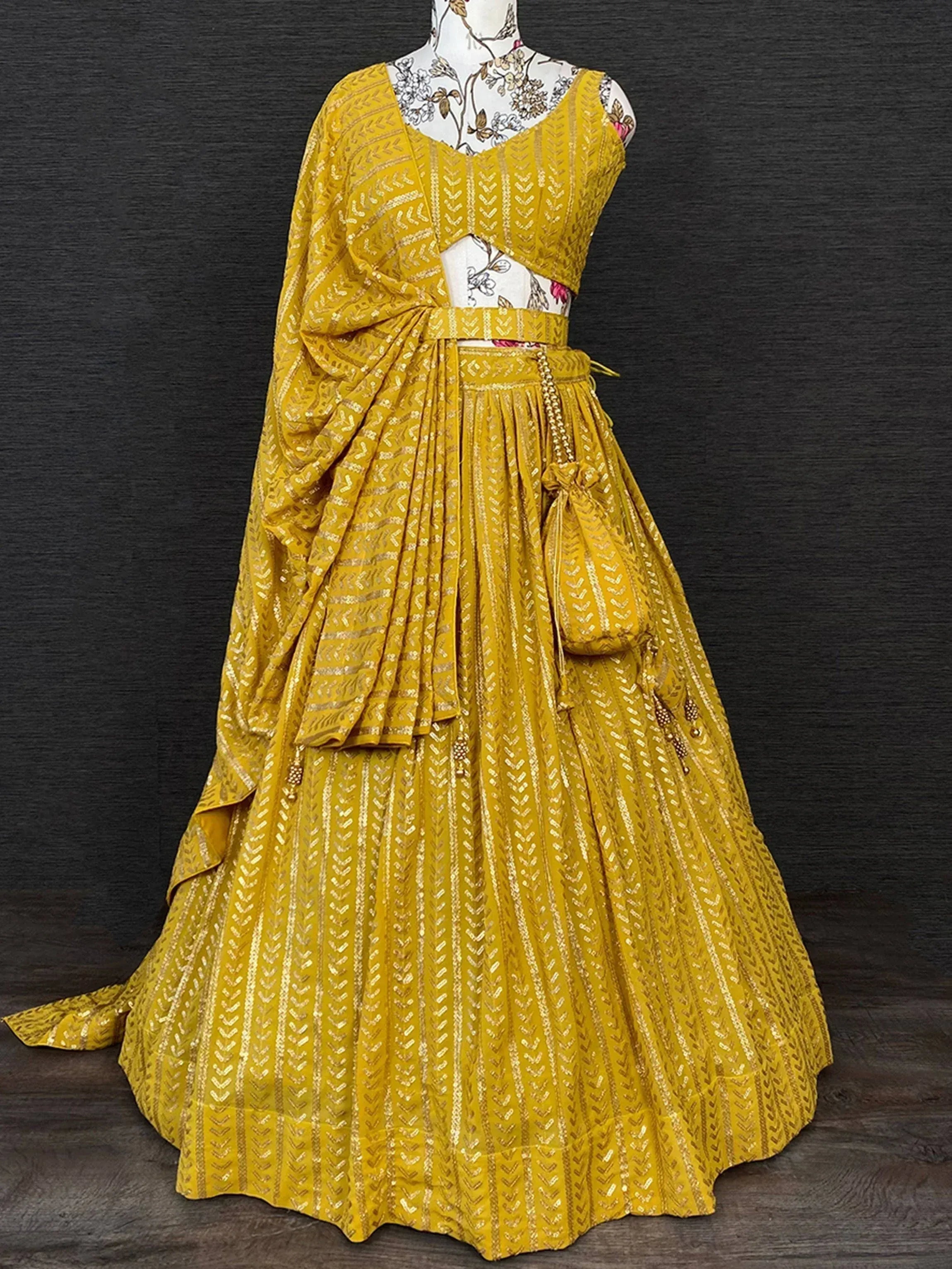 Mustard yellow lehenga choli with gold geometric print, pleated skirt, and matching dupatta for Indian ethnic wear