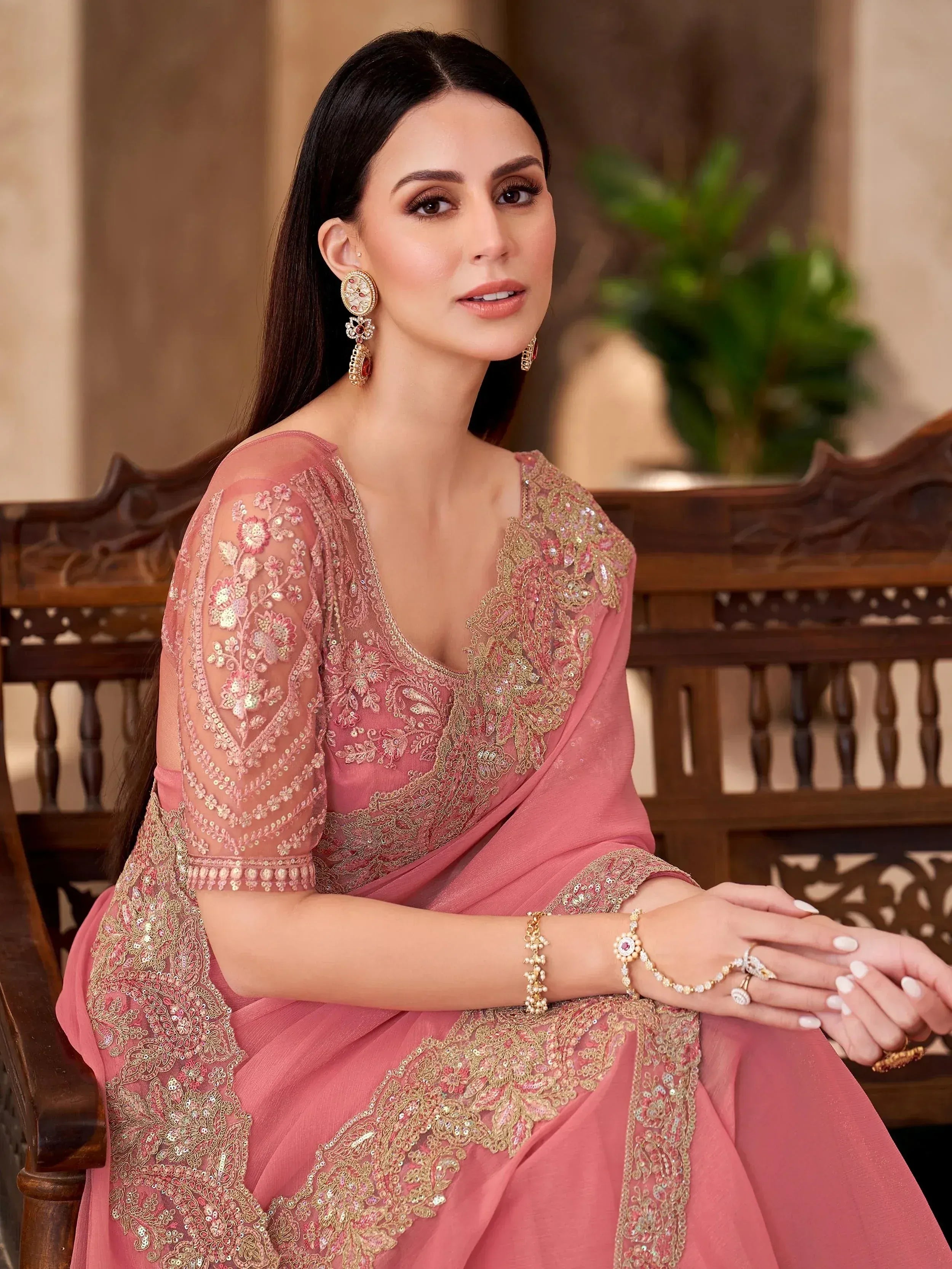 Elegant pink embroidered saree with gold detailing, perfect for Indian ethnic wear occasions.