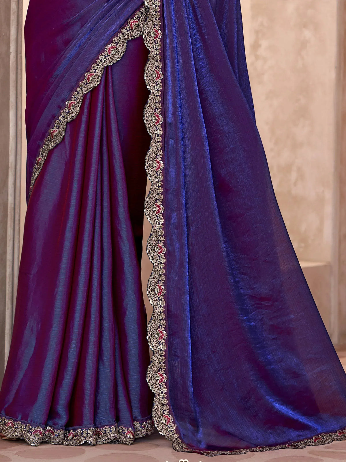 Elegant purple saree with intricate gold and red embroidery, perfect for Indian ethnic wear.