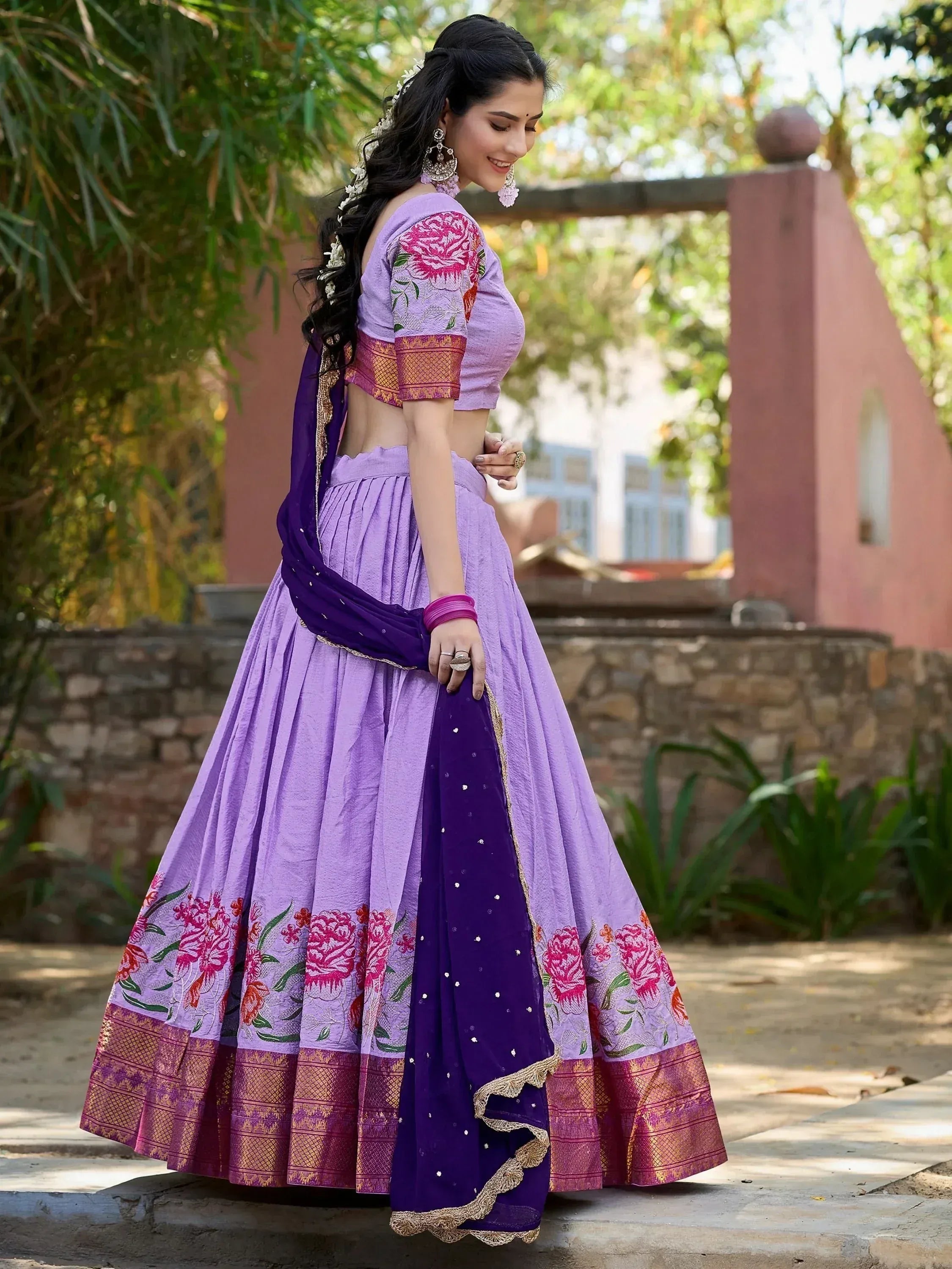 Purple floral lehenga choli with gold border, perfect for Indian ethnic wear and festive occasions.