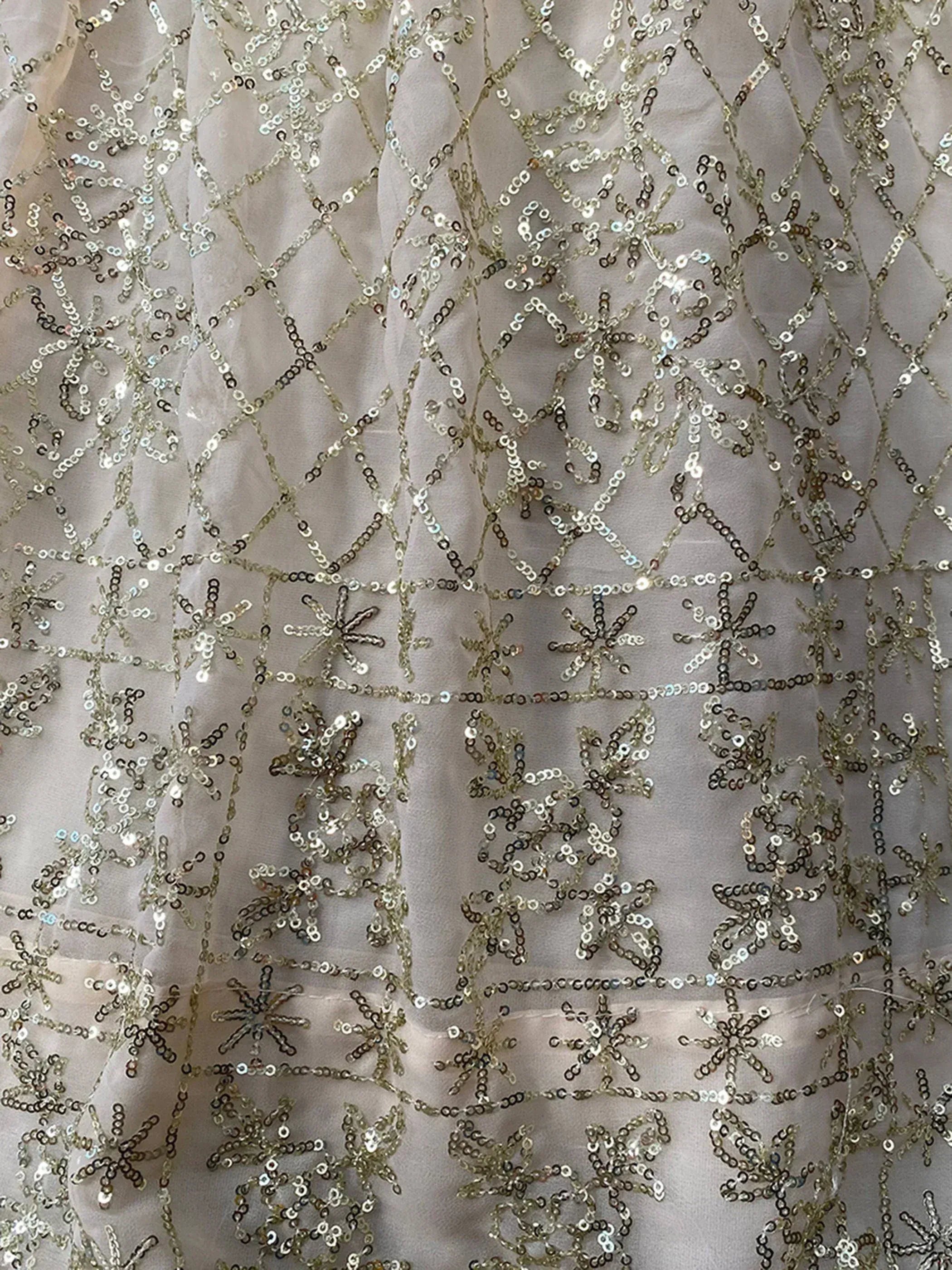 Elegant silver sequin embroidery on sheer fabric, perfect for designer ethnic wear like lehenga or gown.