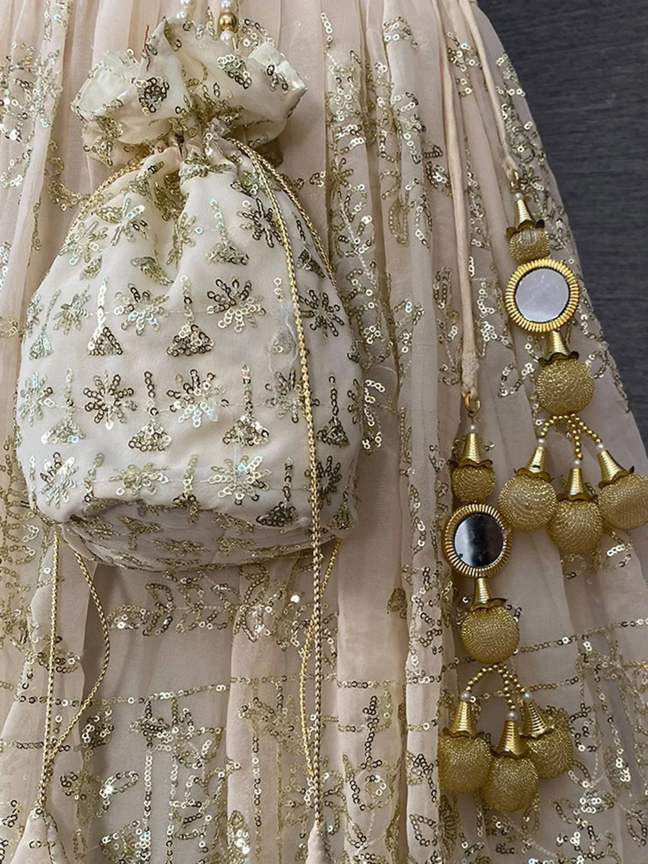 Elegant beige lehenga choli with gold sequin embroidery and mirror work, perfect for Indian ethnic wear.