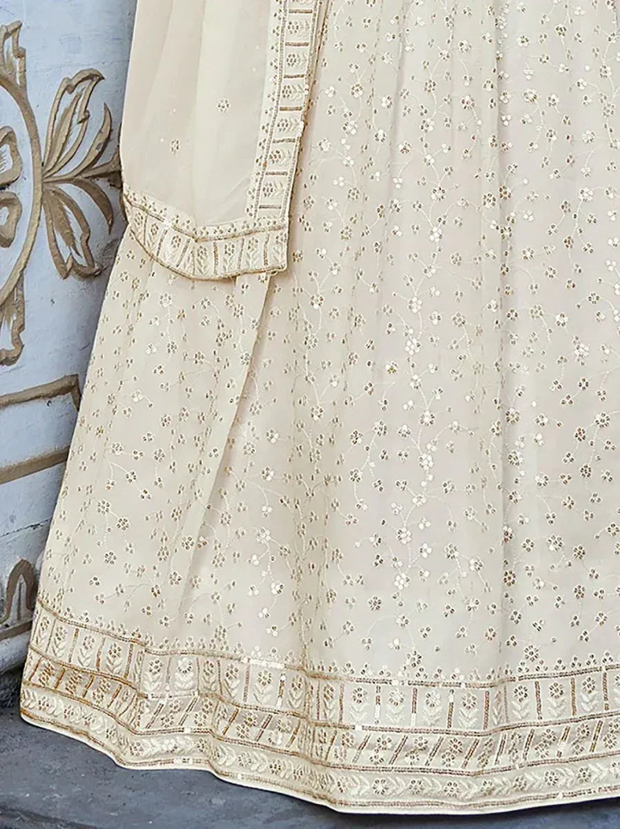 Cream embroidered lehenga with floral motifs and gold border, ideal for Indian ethnic wear occasions