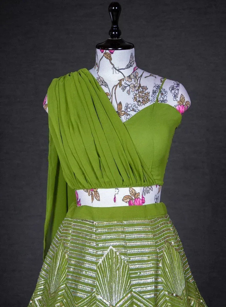 Green ethnic gown with pleated drape and sequin skirt, floral waistband, designer Indian wear