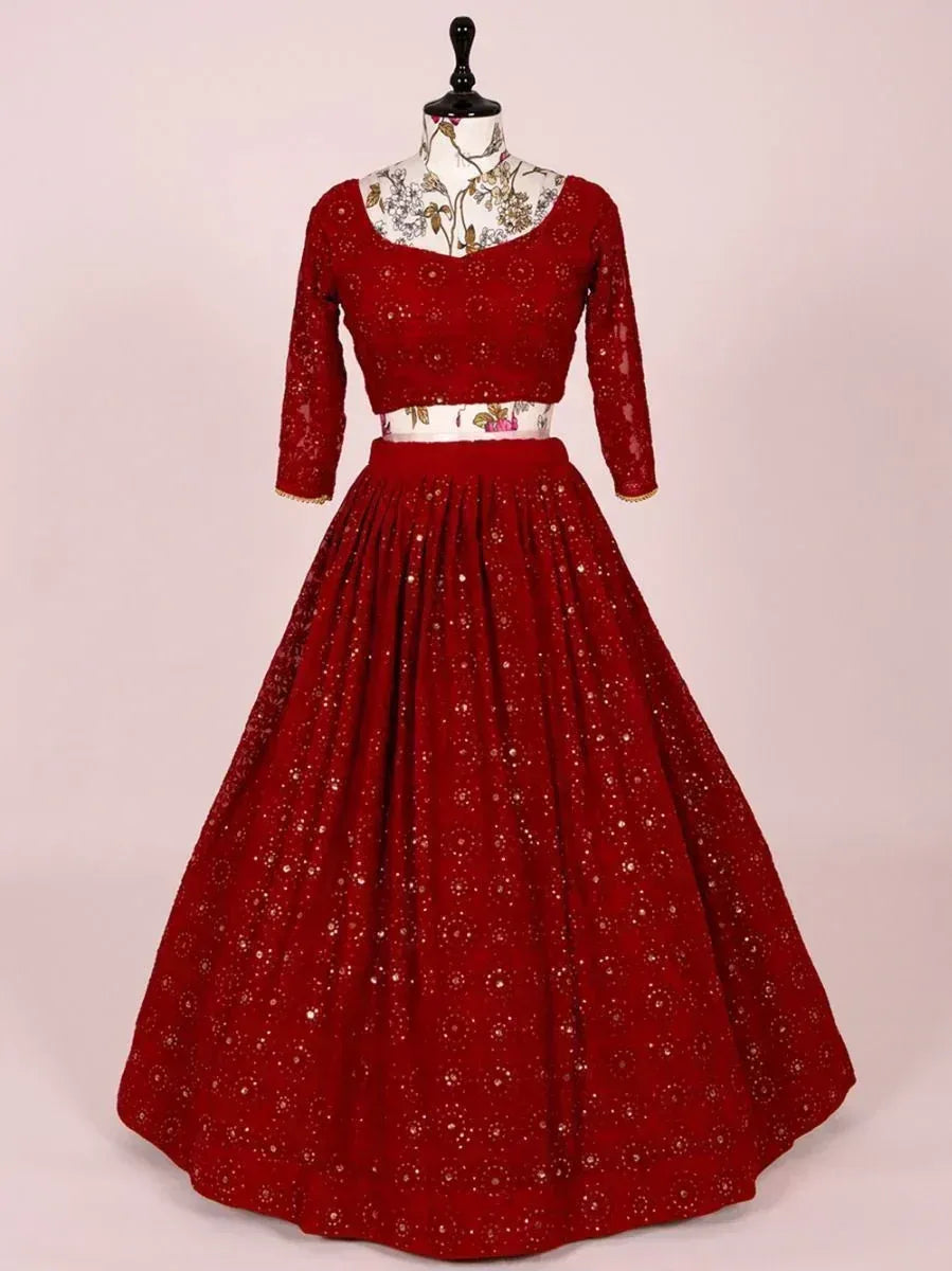Red embroidered lehenga choli with floral lace top and flared skirt, perfect for Indian ethnic occasions