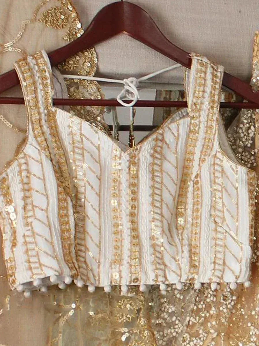 White and gold embroidered lehenga choli blouse with sequins and pom-poms, perfect for Indian ethnic wear
