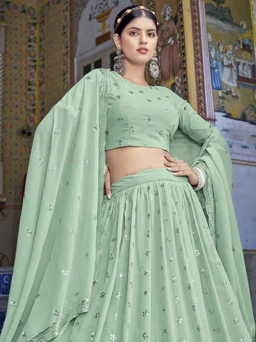 Mint green designer lehenga choli with floral embroidery, perfect for Indian ethnic wear occasions.