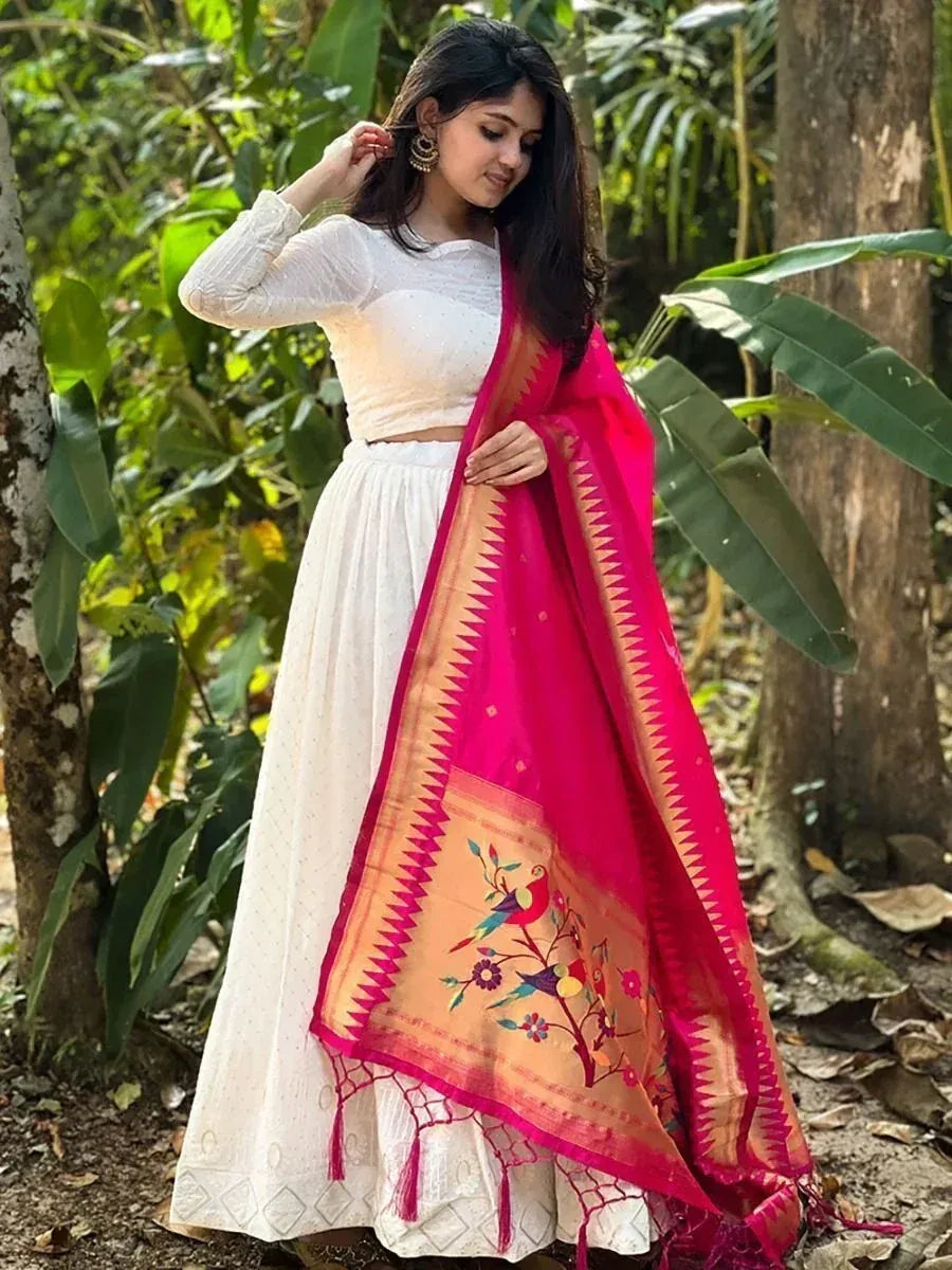 Woman in white ethnic skirt and crop top with pink embroidered dupatta, styled for Indian festive wear