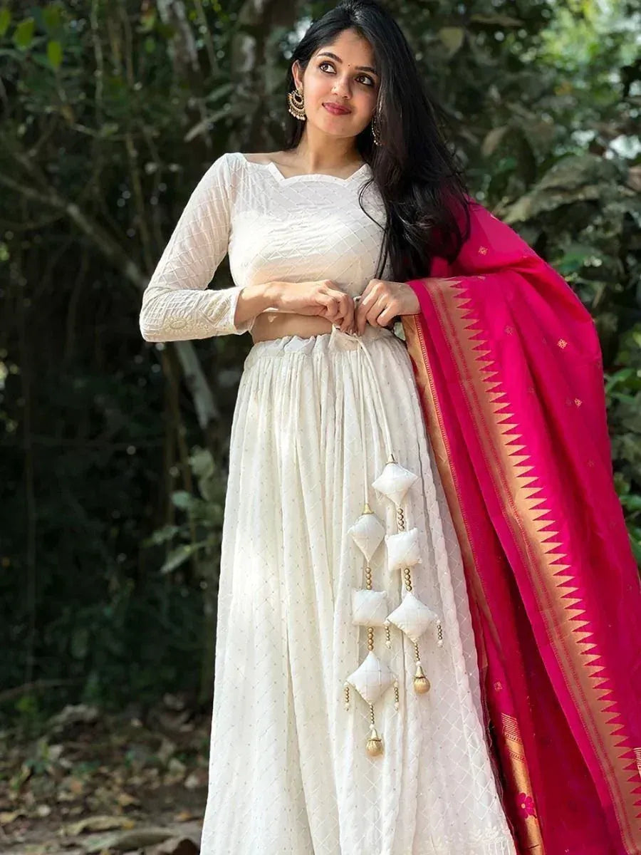 White ethnic lehenga choli with pink dupatta, perfect for Indian weddings and festive occasions