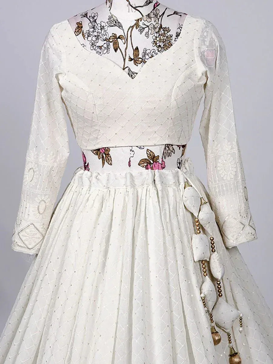 White ethnic gown with floral print neckline, quilted bodice, and tassel detailing for Indian occasions