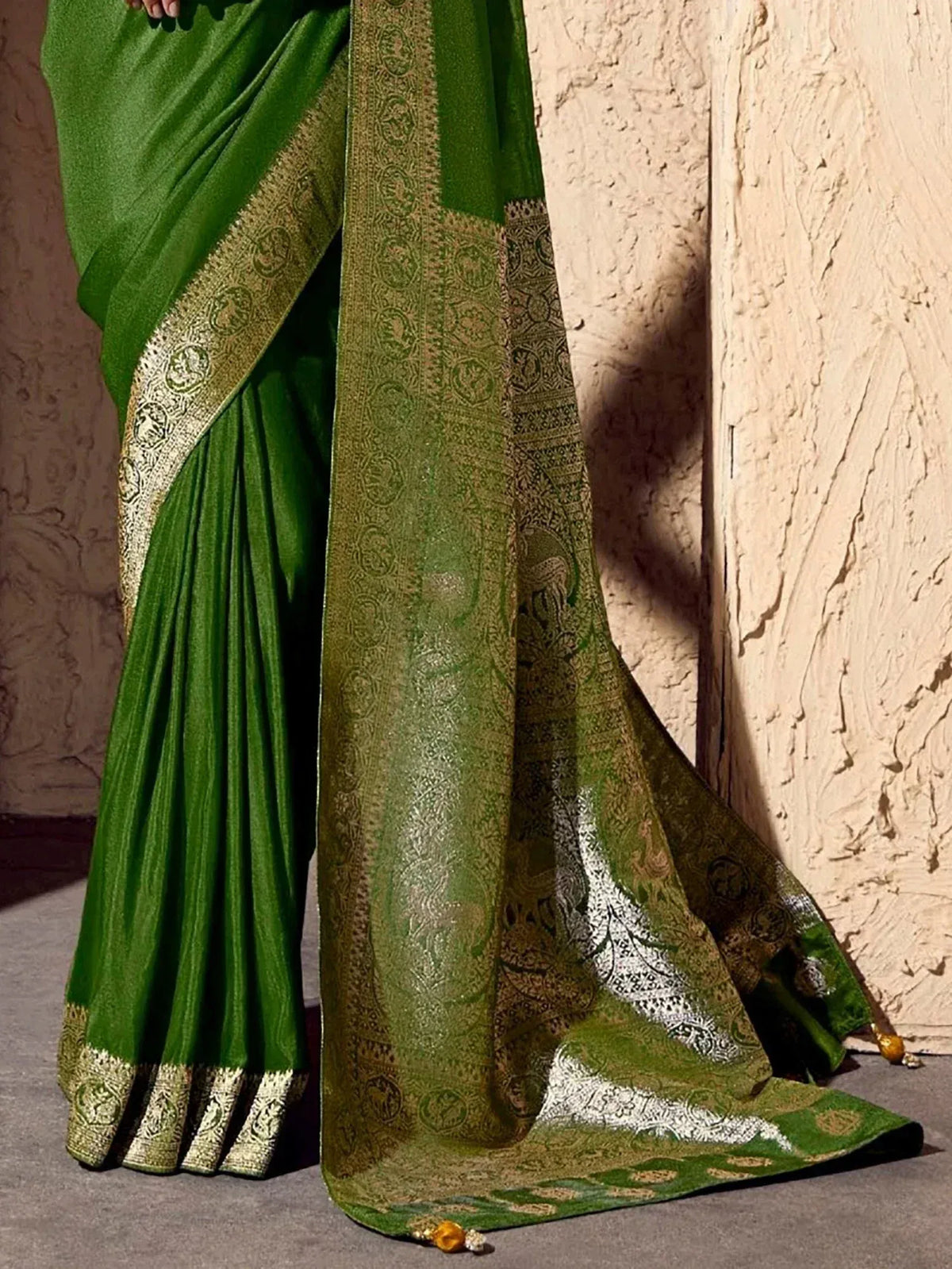 Green ethnic saree with gold embroidery and intricate border design