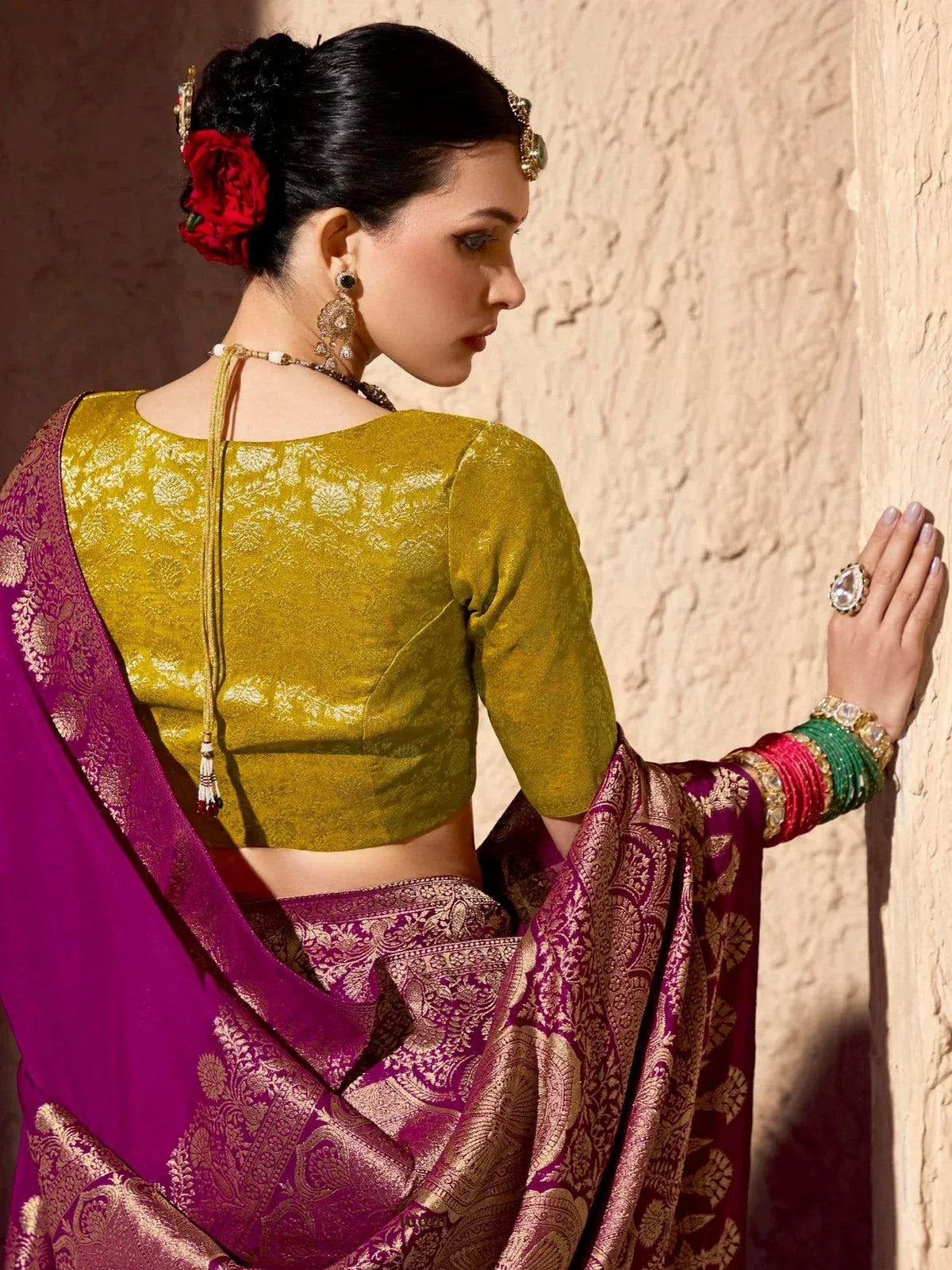 Woman in purple and gold saree with green blouse, traditional Indian ethnic wear