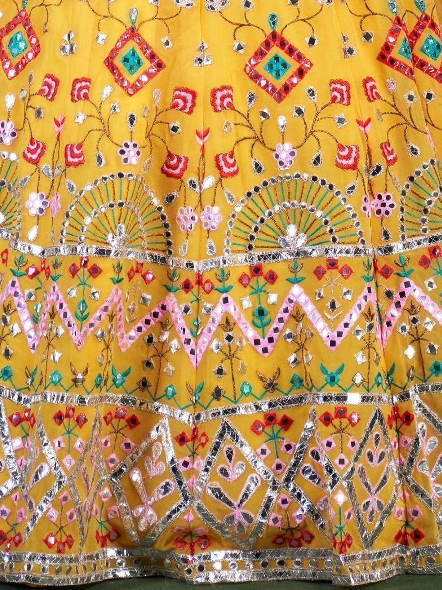Yellow ethnic lehenga with mirror work, floral embroidery, and geometric patterns for Indian weddings