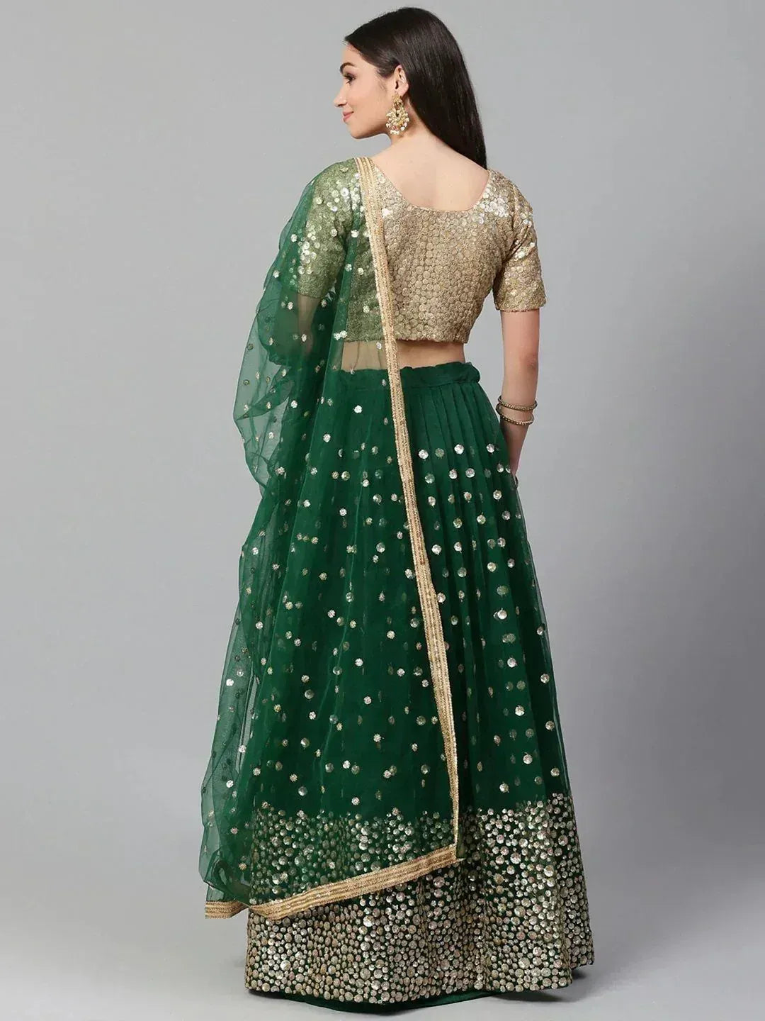 Emerald green lehenga choli with gold sequin embroidery and sheer dupatta, perfect for Indian weddings and festive occasions.