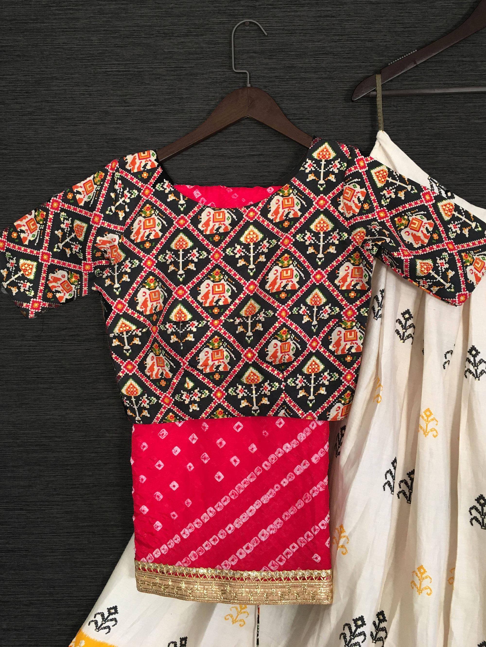 Black and red printed ethnic blouse with elephant motifs, paired with white skirt, ideal for Indian wear