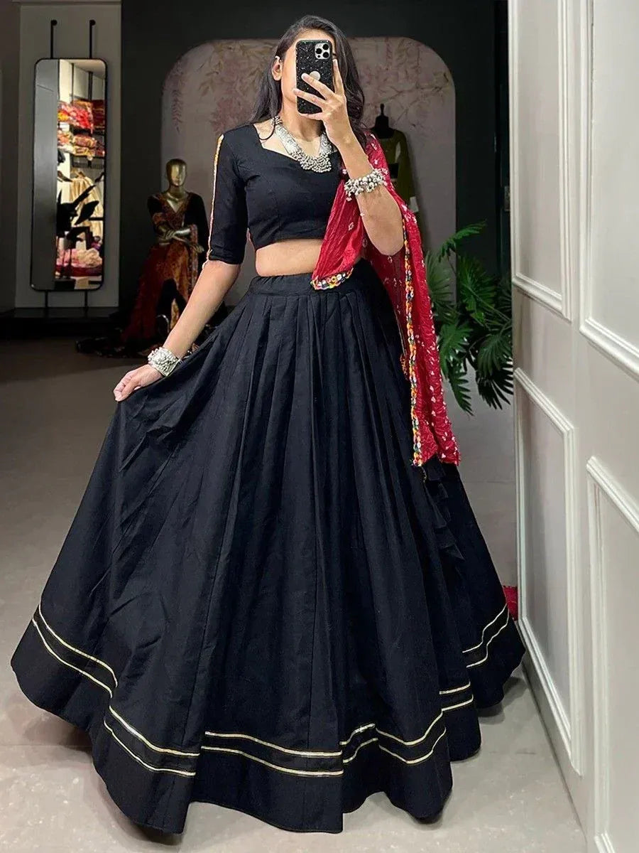 Black lehenga choli with gold trim and red dupatta, ethnic Indian wear for women