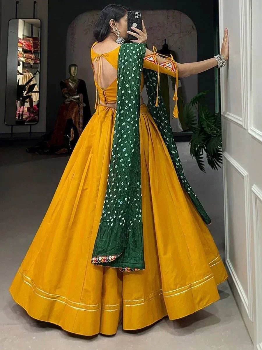 Yellow lehenga choli with green dupatta, backless blouse, ethnic Indian wear for women