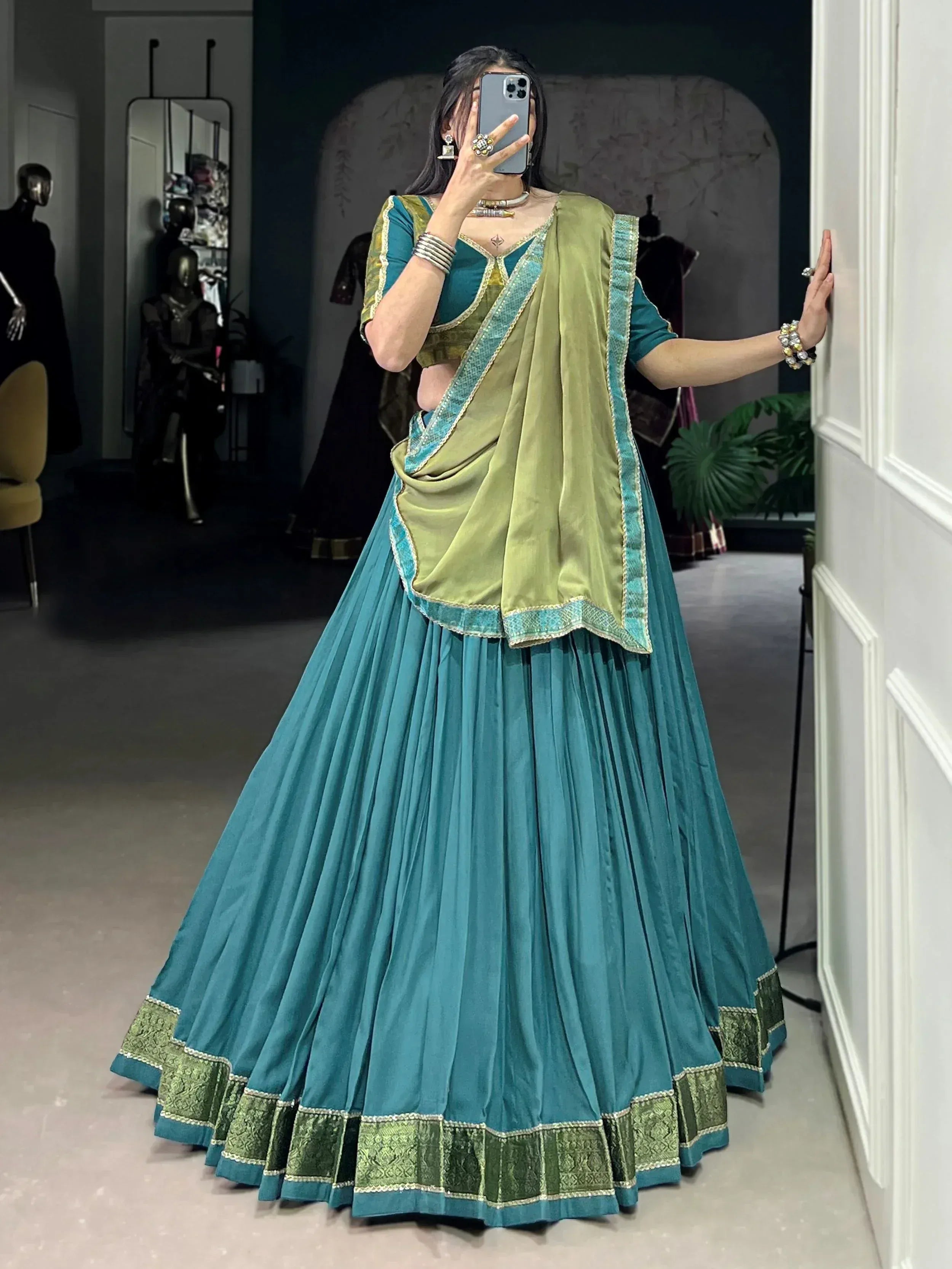 Teal and olive green designer lehenga choli with embroidered dupatta, perfect for Indian ethnic occasions.