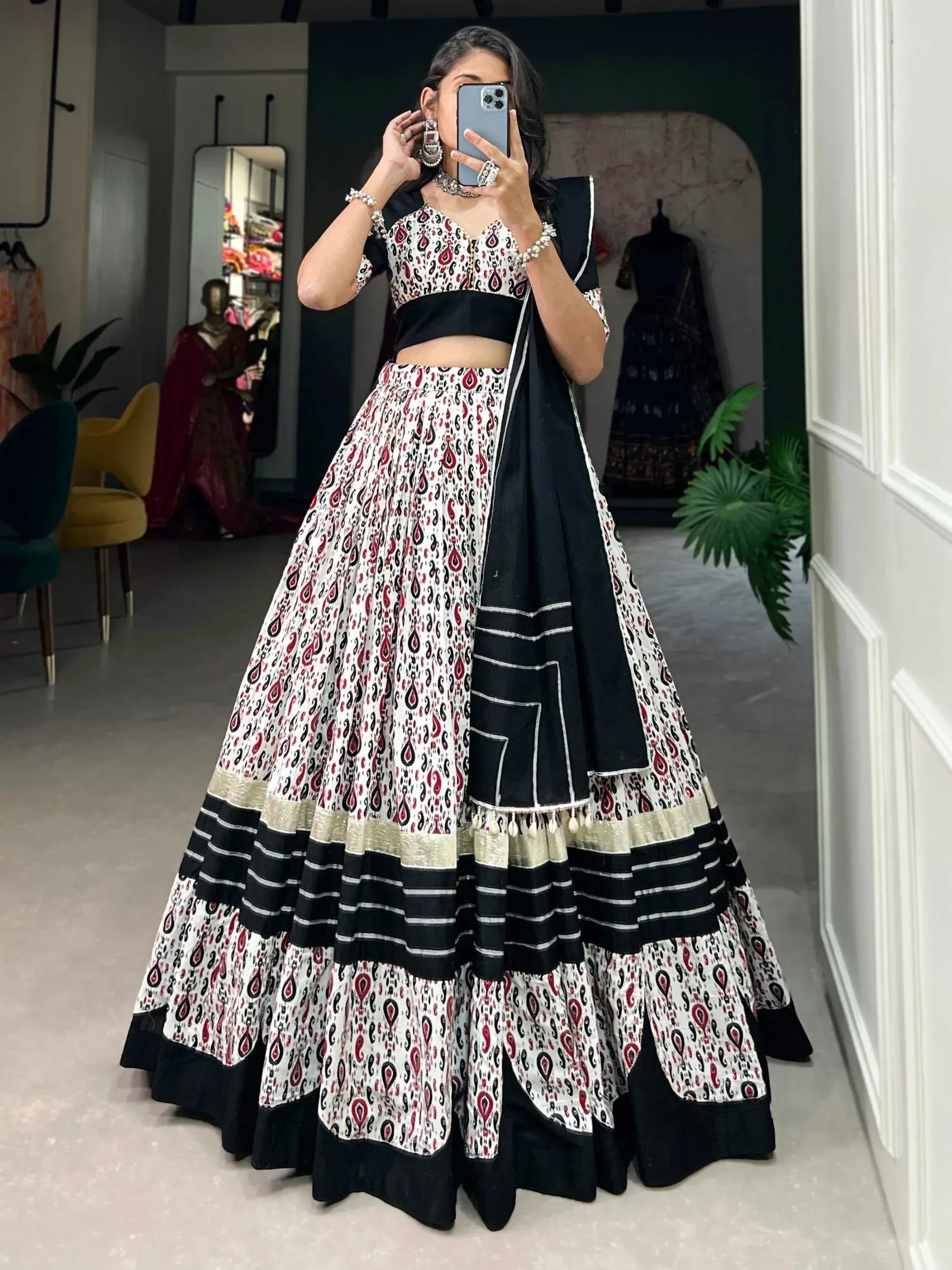 Woman in black and white printed lehenga choli with dupatta, ethnic Indian wear for festive occasions